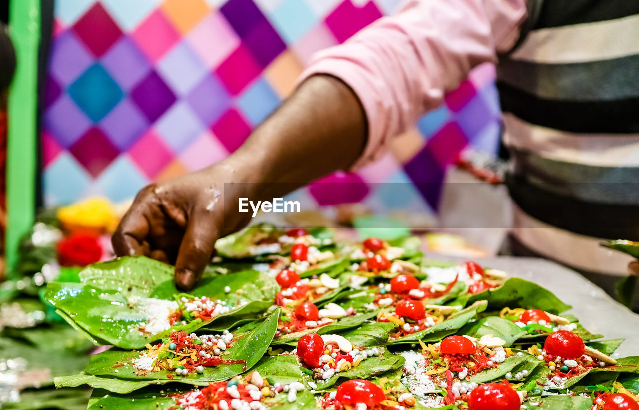 CLOSE-UP OF PERSON PREPARING FRUITS