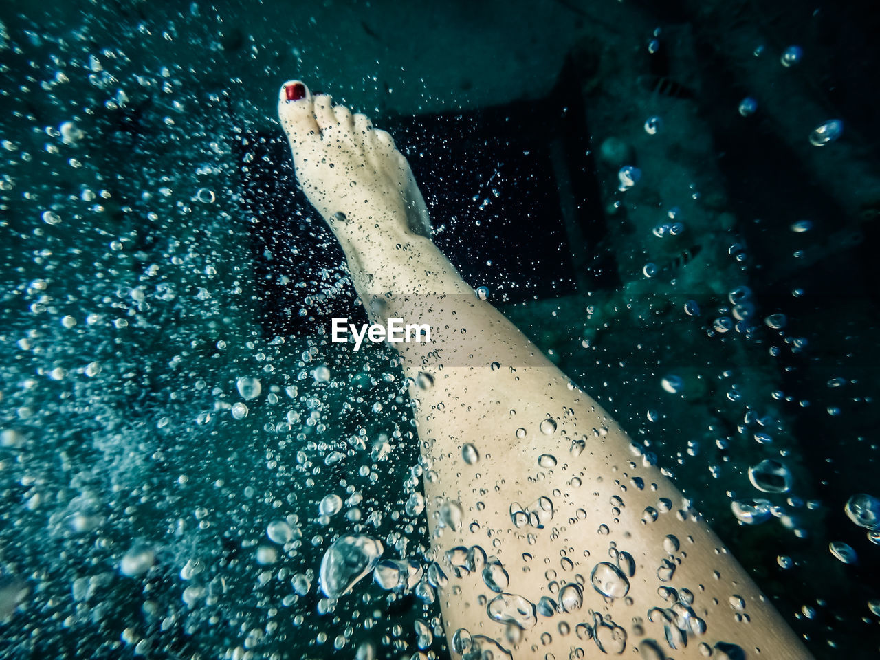 Low section of young woman in swimming pool