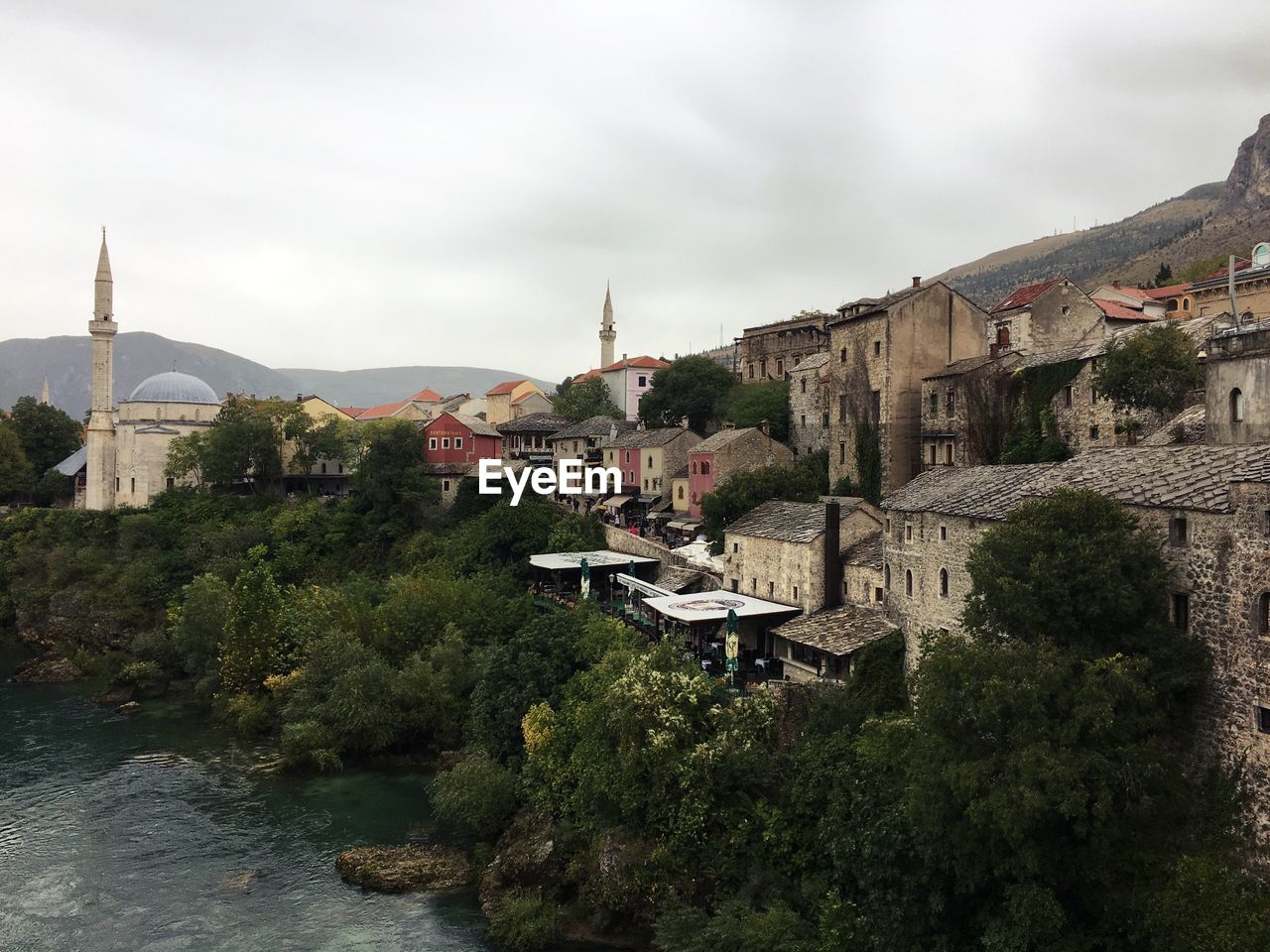 Town by mountain against sky