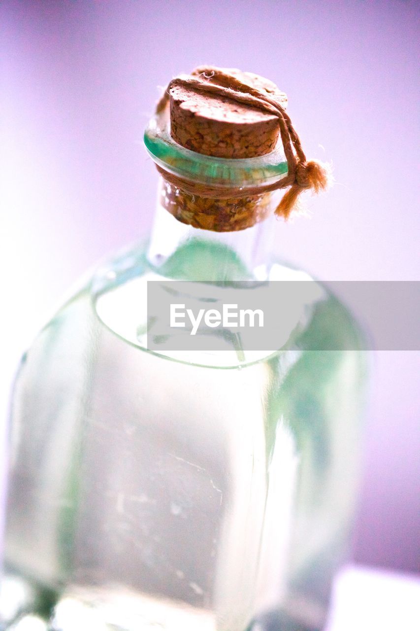 Close-up of bottle against pink background