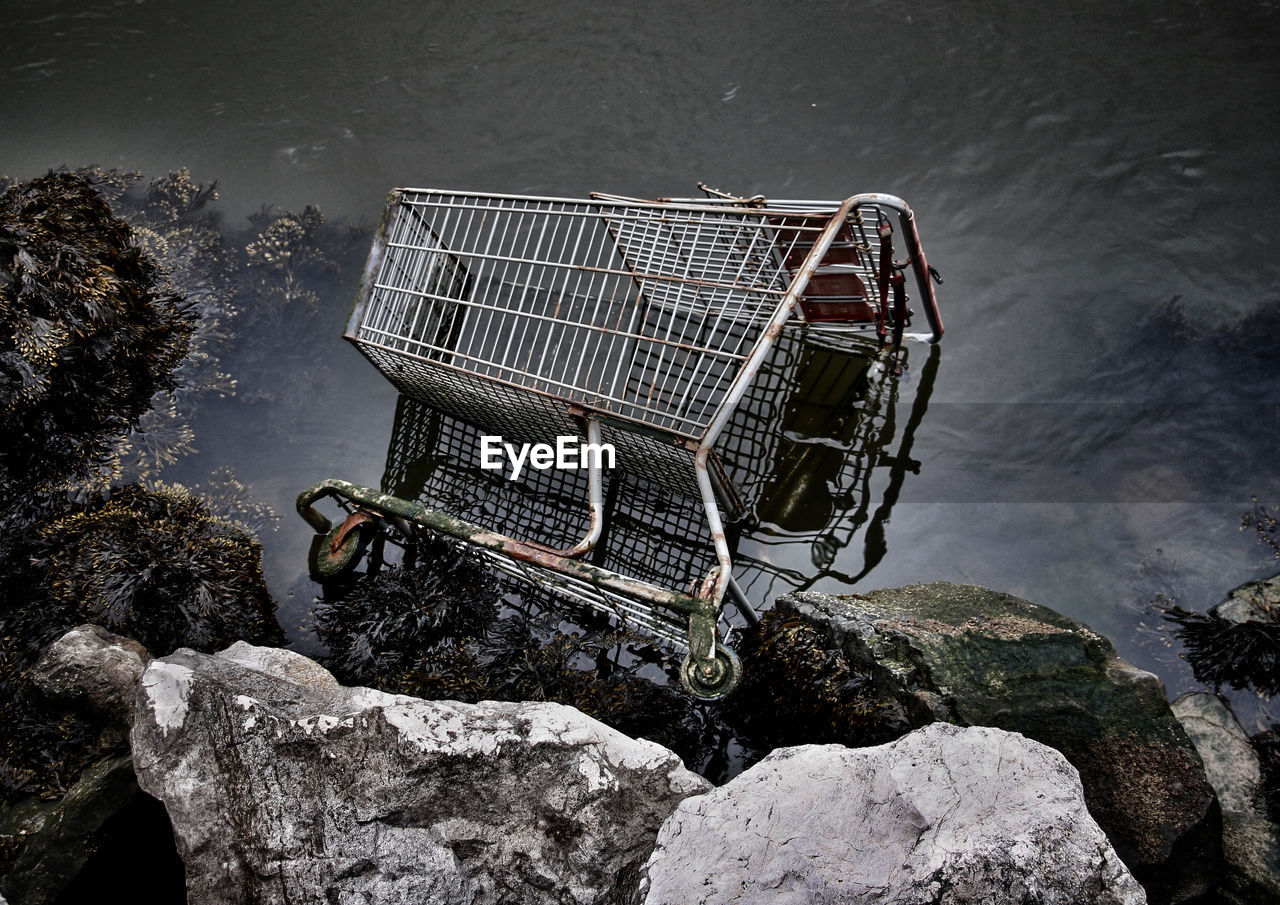 High angle view of abandoned shopping cart in lake
