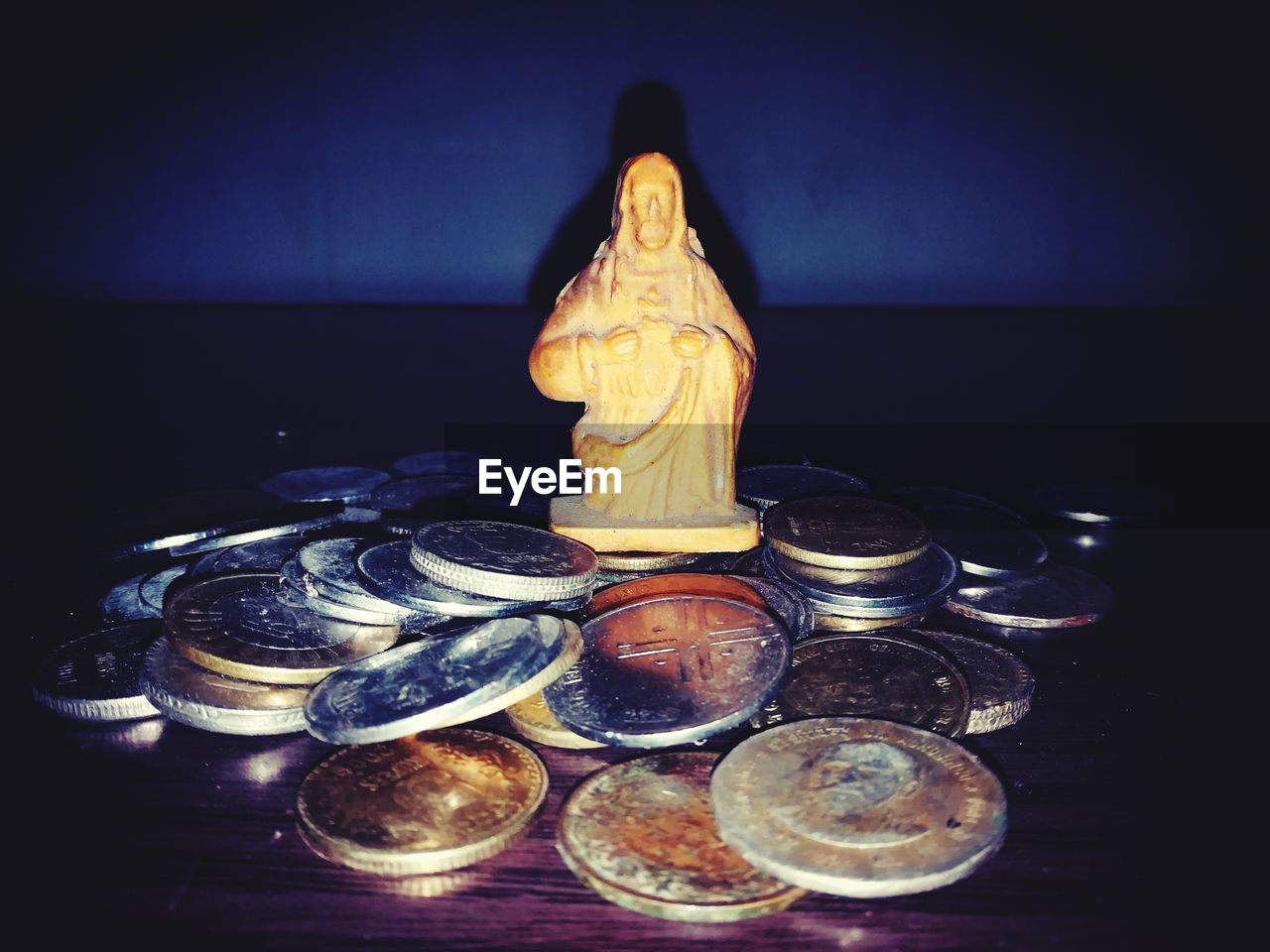 CLOSE-UP OF STATUE ON TABLE AT NIGHT