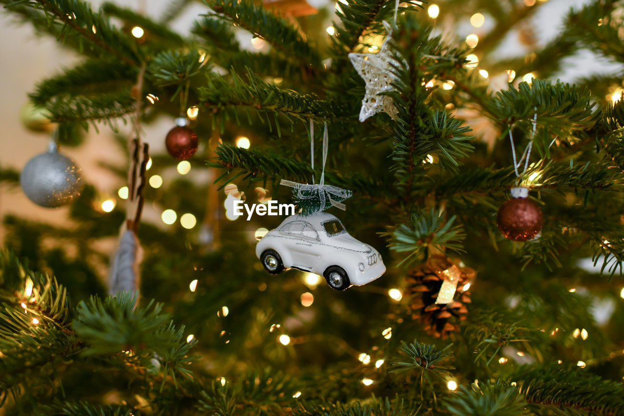 White car and toys hanging on a christmas tree