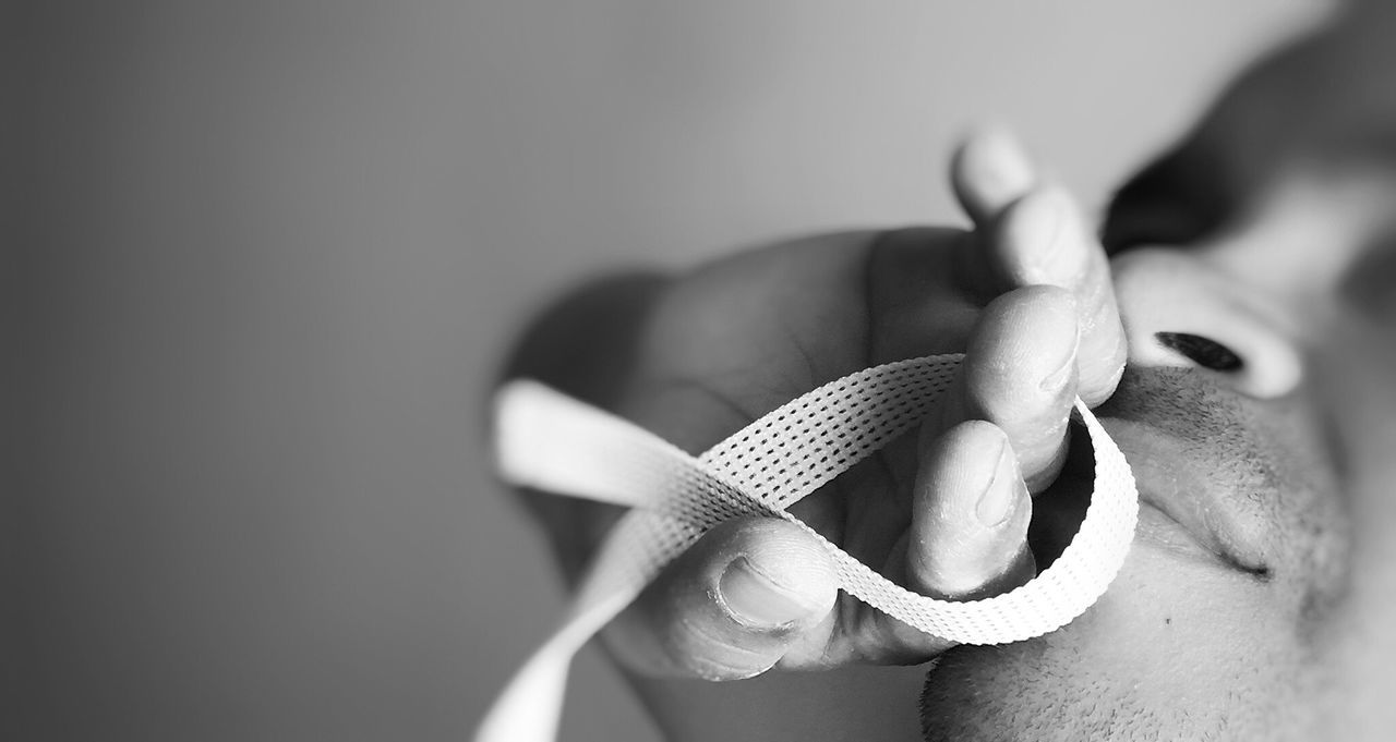 Close-up of the hand of a man holding string