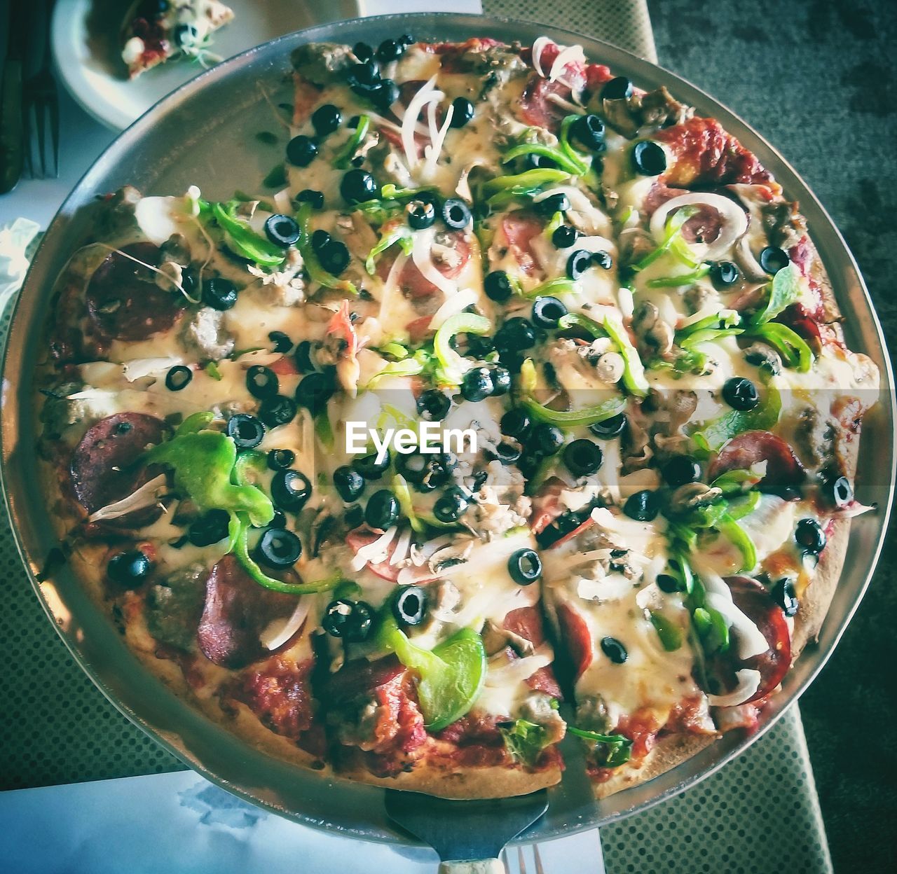 High angle view of a thin crust pizza with toppings.