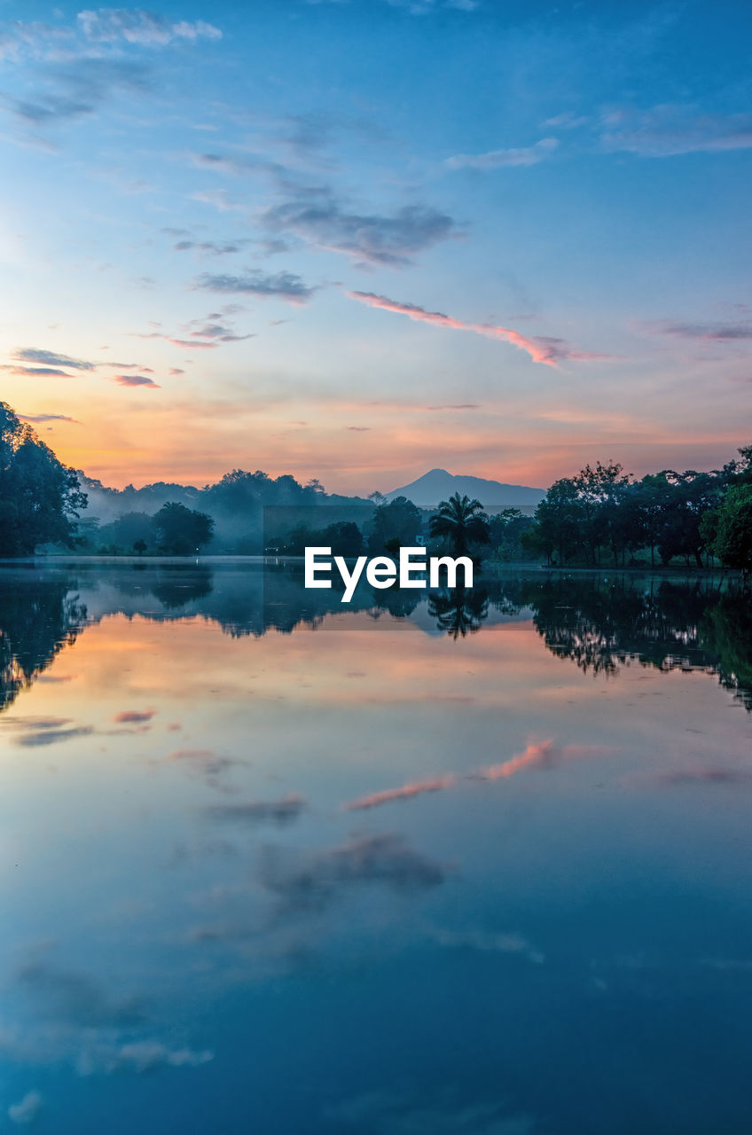 Scenic view of lake against romantic sky at sunset