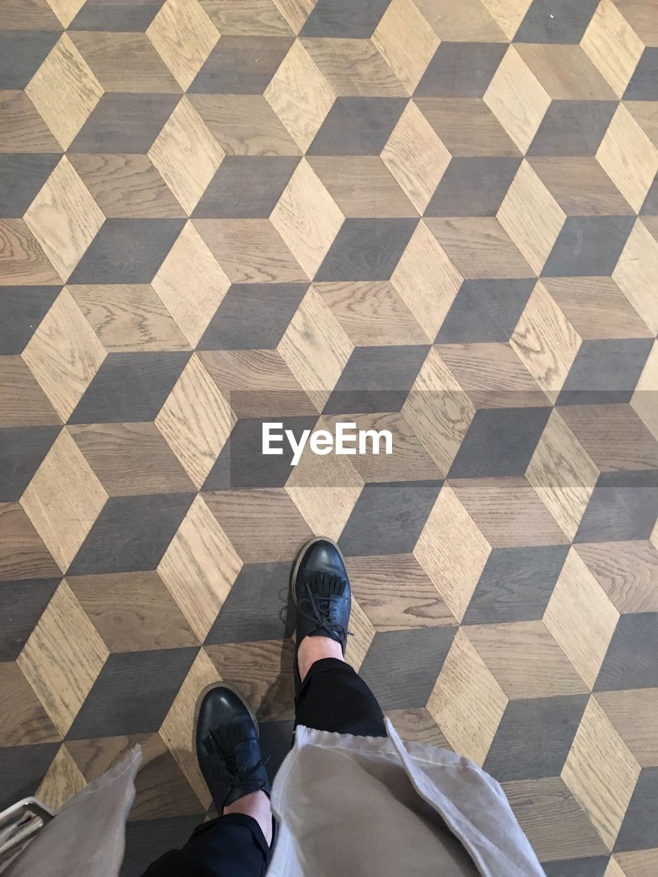 Low section of woman standing on tiled floor