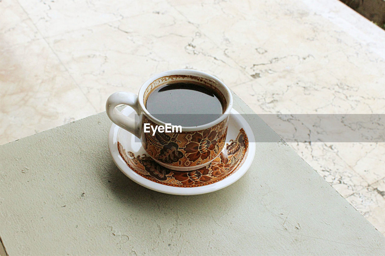 A high angle shot of batik pattern coffee cup