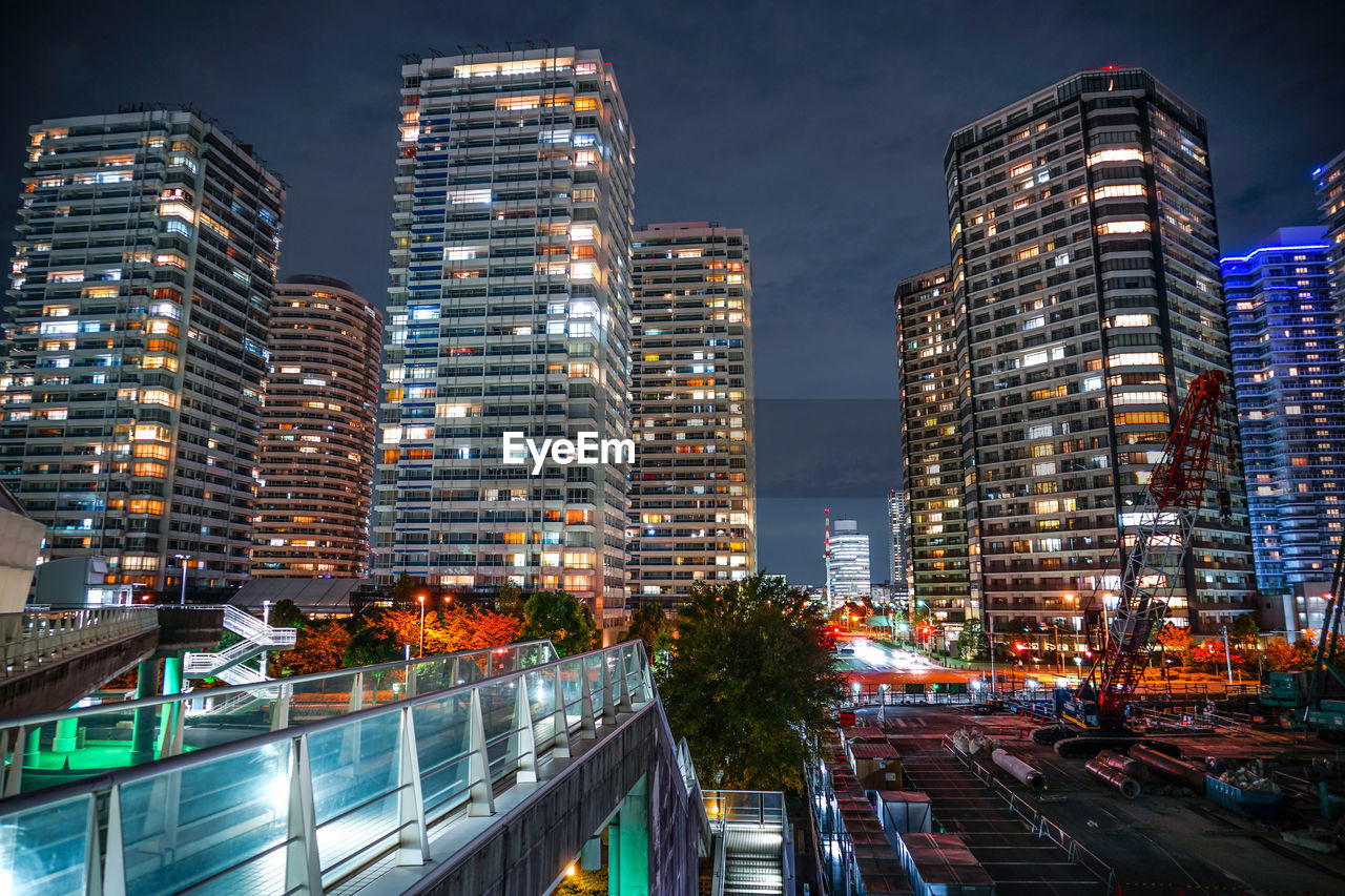 ILLUMINATED BUILDINGS AGAINST SKY AT NIGHT