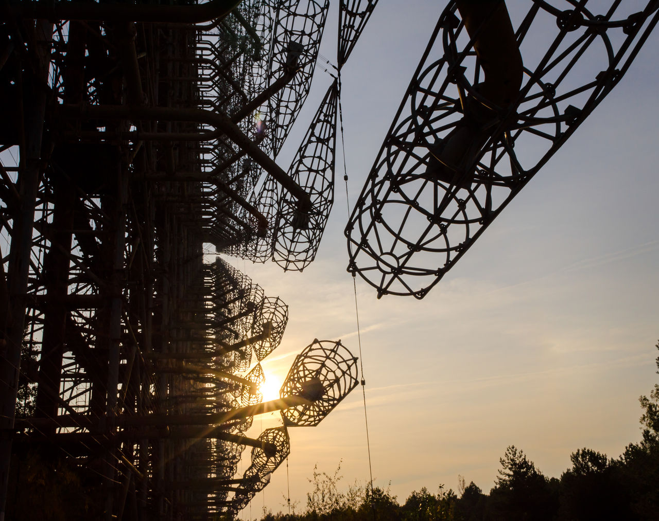 LOW ANGLE VIEW OF SILHOUETTE ROLLERCOASTER AGAINST SKY AT SUNSET