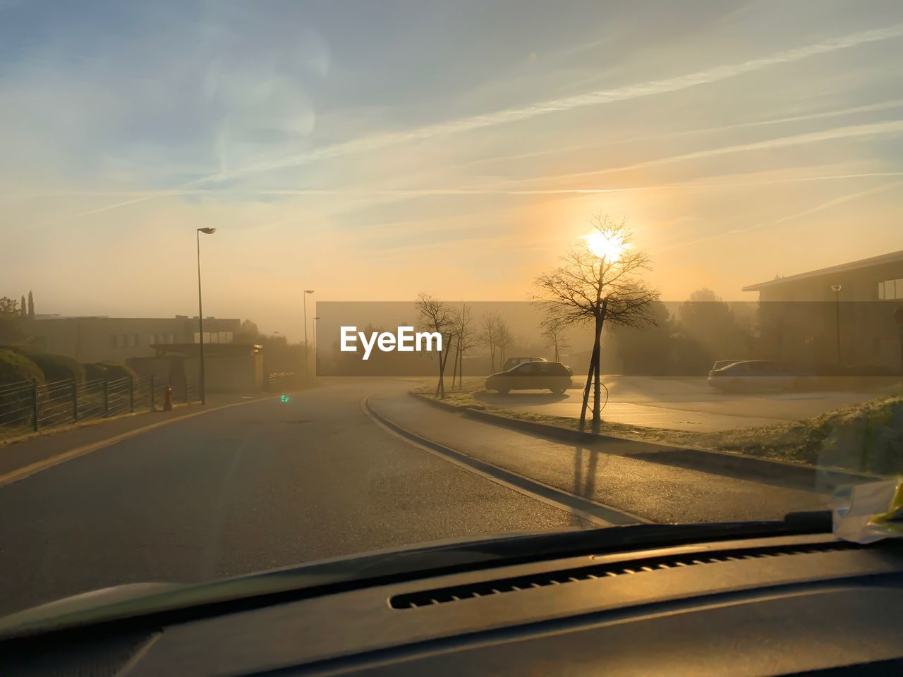 ROAD AGAINST SKY SEEN FROM CAR WINDSHIELD