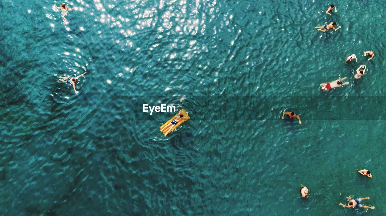 High angle view of people swimming in sea