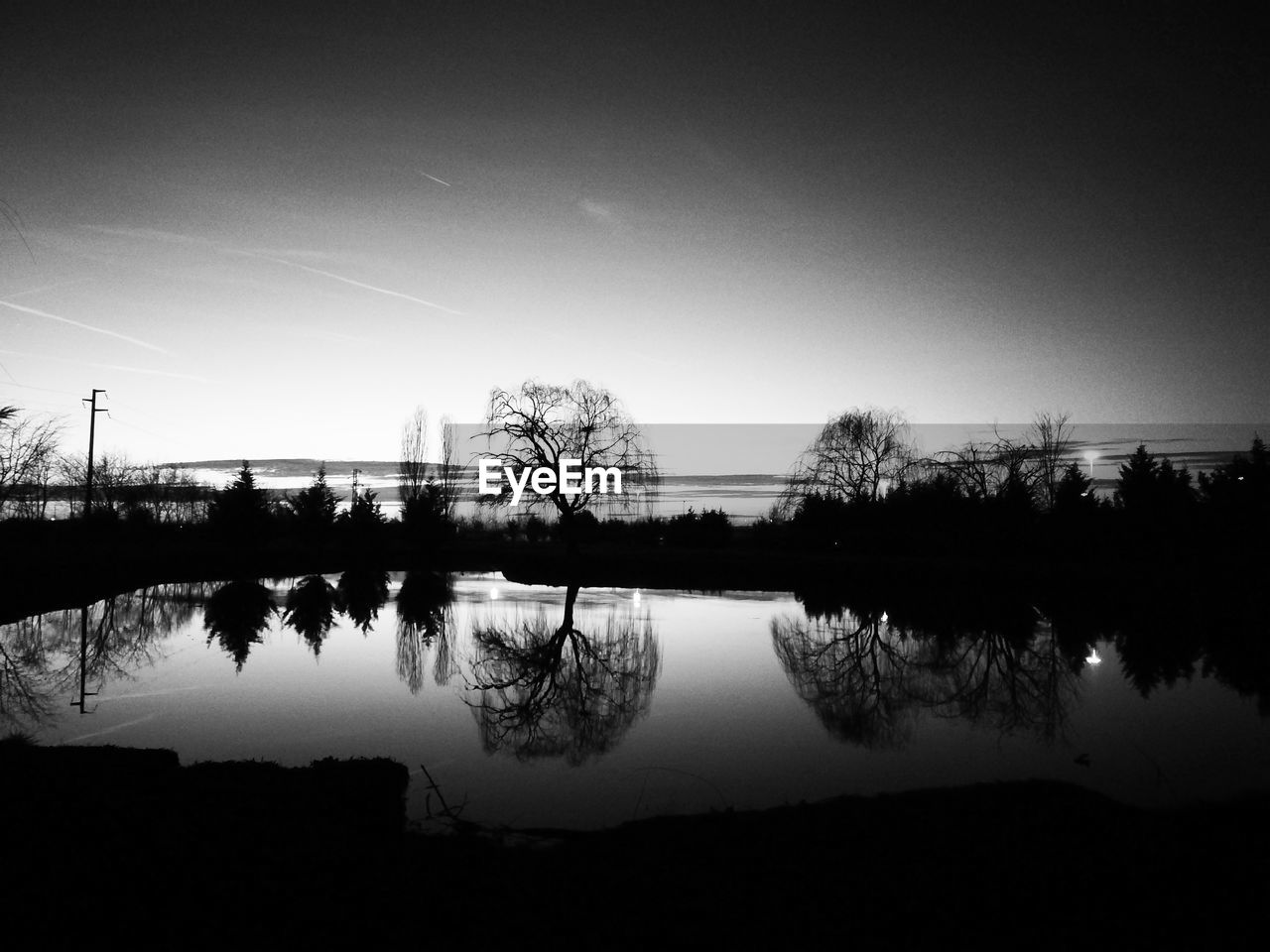 SILHOUETTE TREES BY LAKE AGAINST SKY