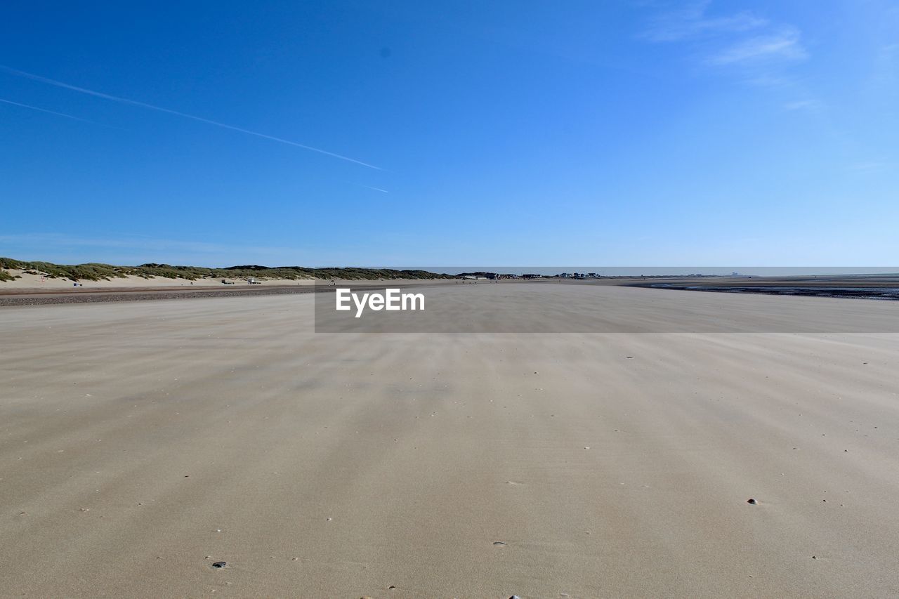 Scenic view of desert against clear blue sky