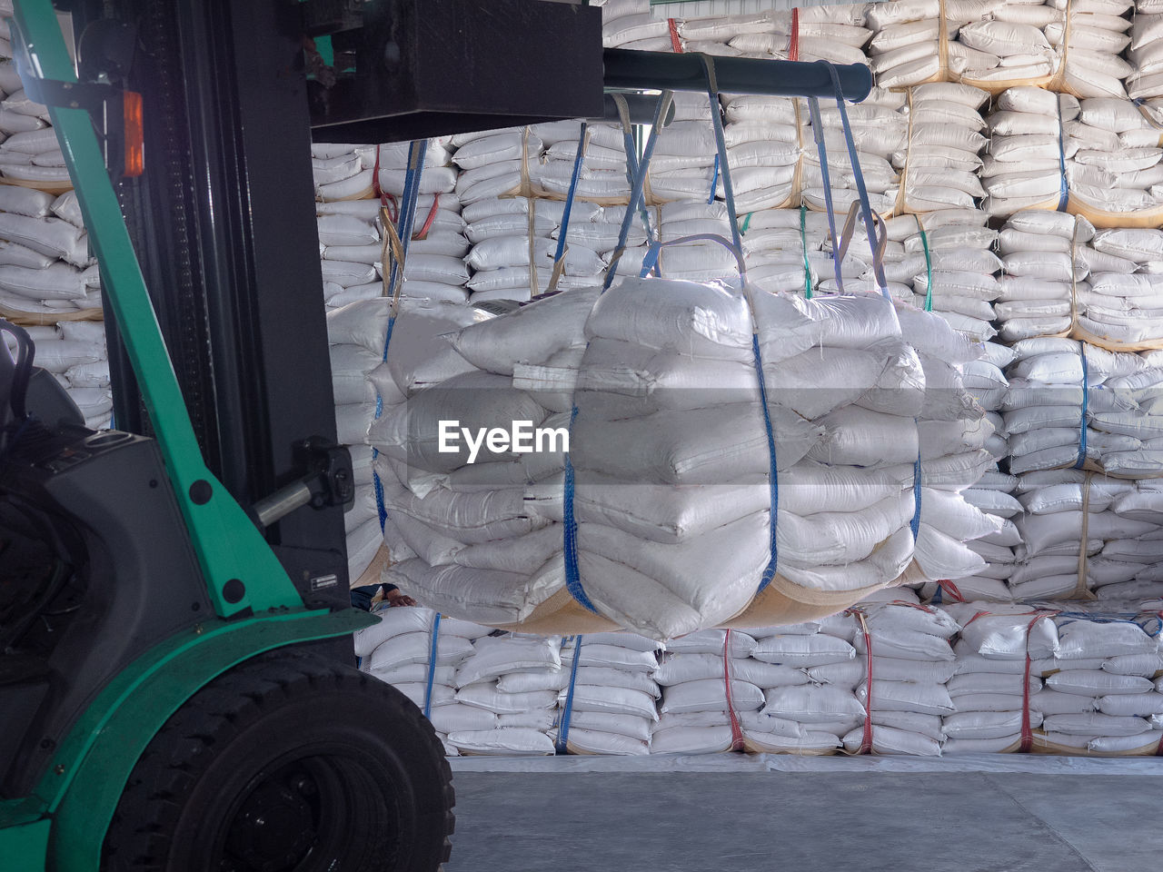 Sugar sacks hanging on forklift in factory