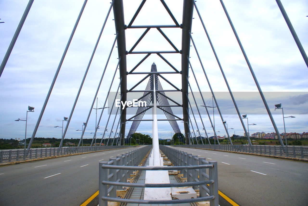 Road by bridge against sky