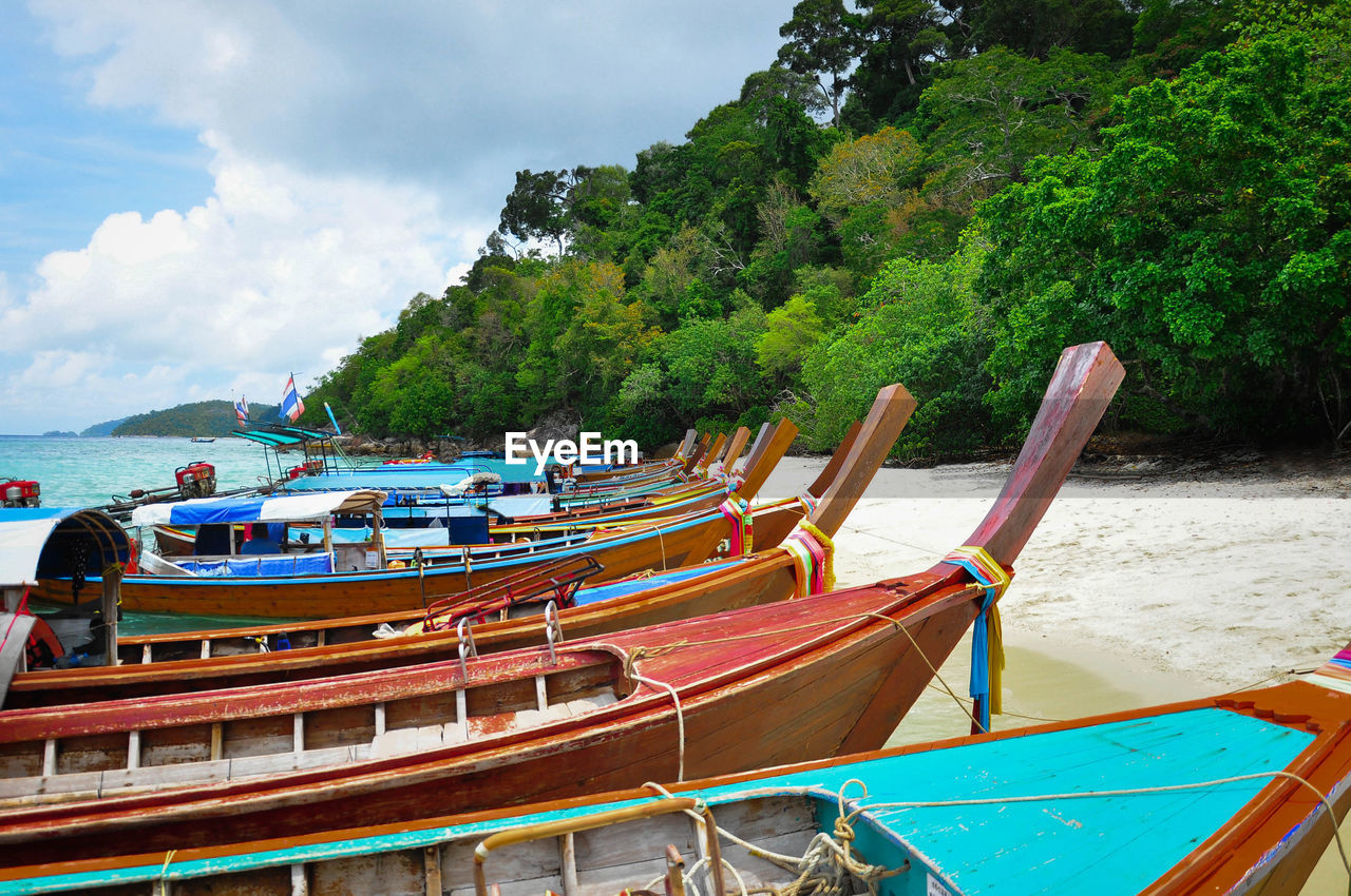 Boats moored on sea against sky