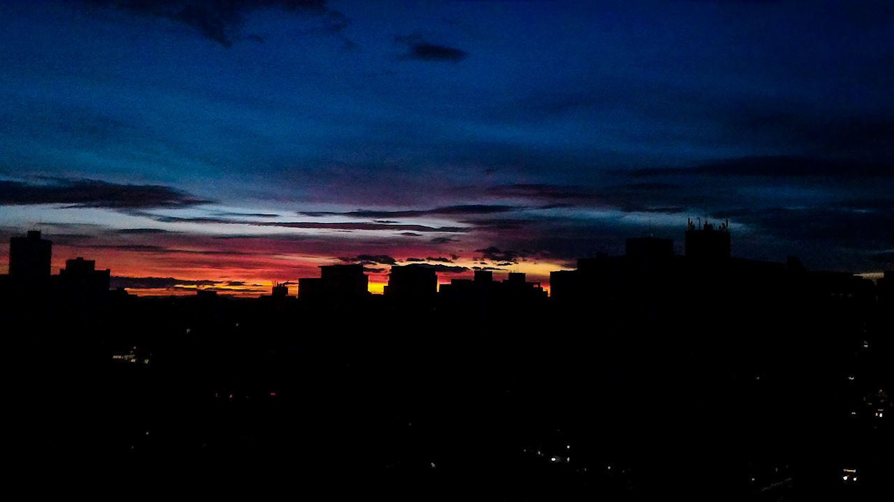 SILHOUETTE CITYSCAPE AGAINST SKY DURING NIGHT