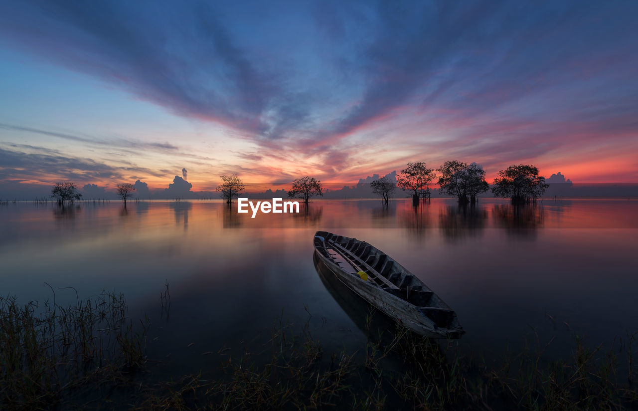 Scenic view of lake against sky during sunset
