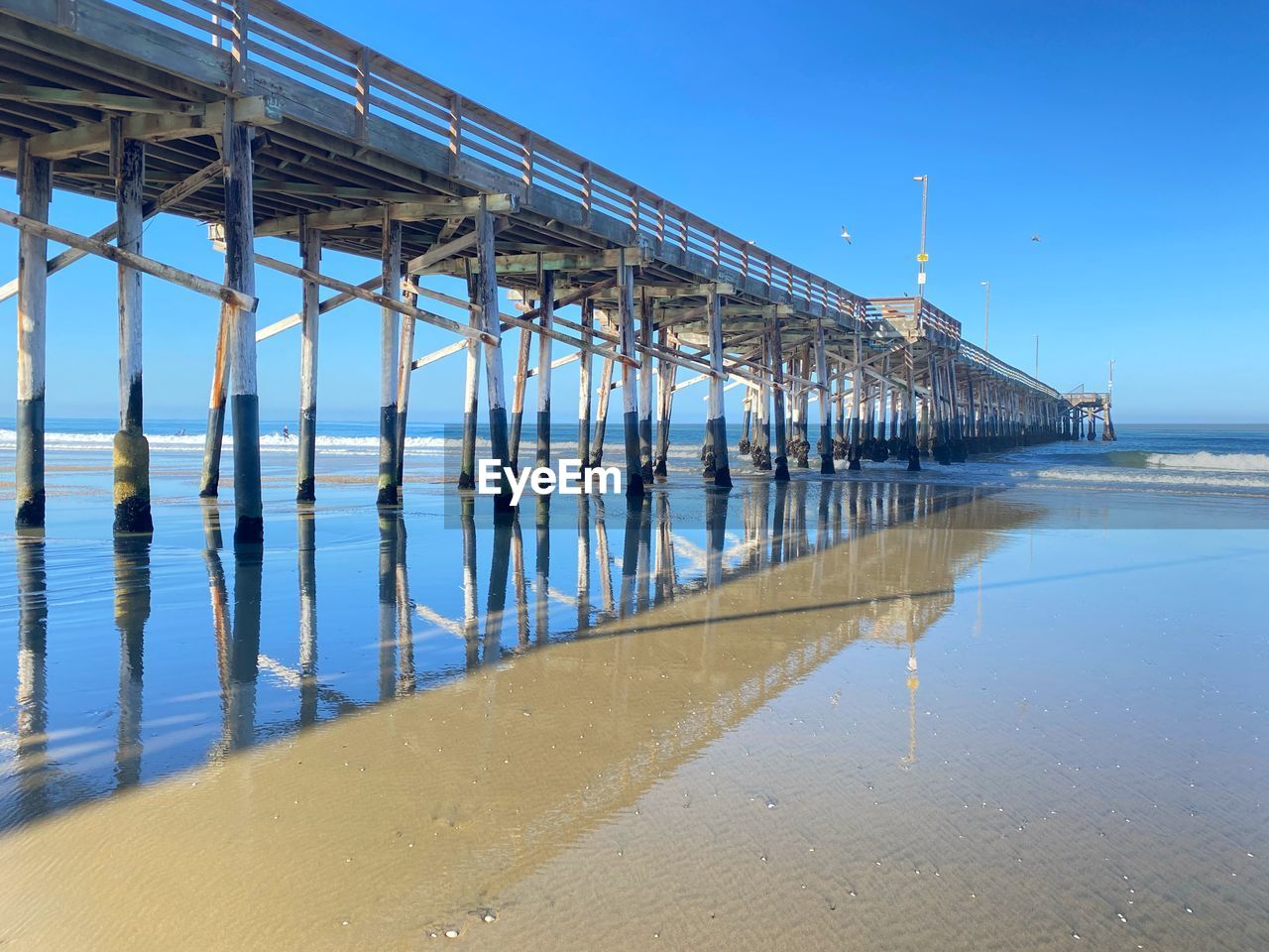 water, sea, sky, beach, land, nature, architecture, pier, blue, built structure, walkway, sand, no people, day, clear sky, beauty in nature, scenics - nature, reflection, bridge, outdoors, ocean, travel destinations, tranquility, travel, coast, shore, sunny, environment, coastline, horizon over water, horizon, sunlight, transportation, tranquil scene, tourism