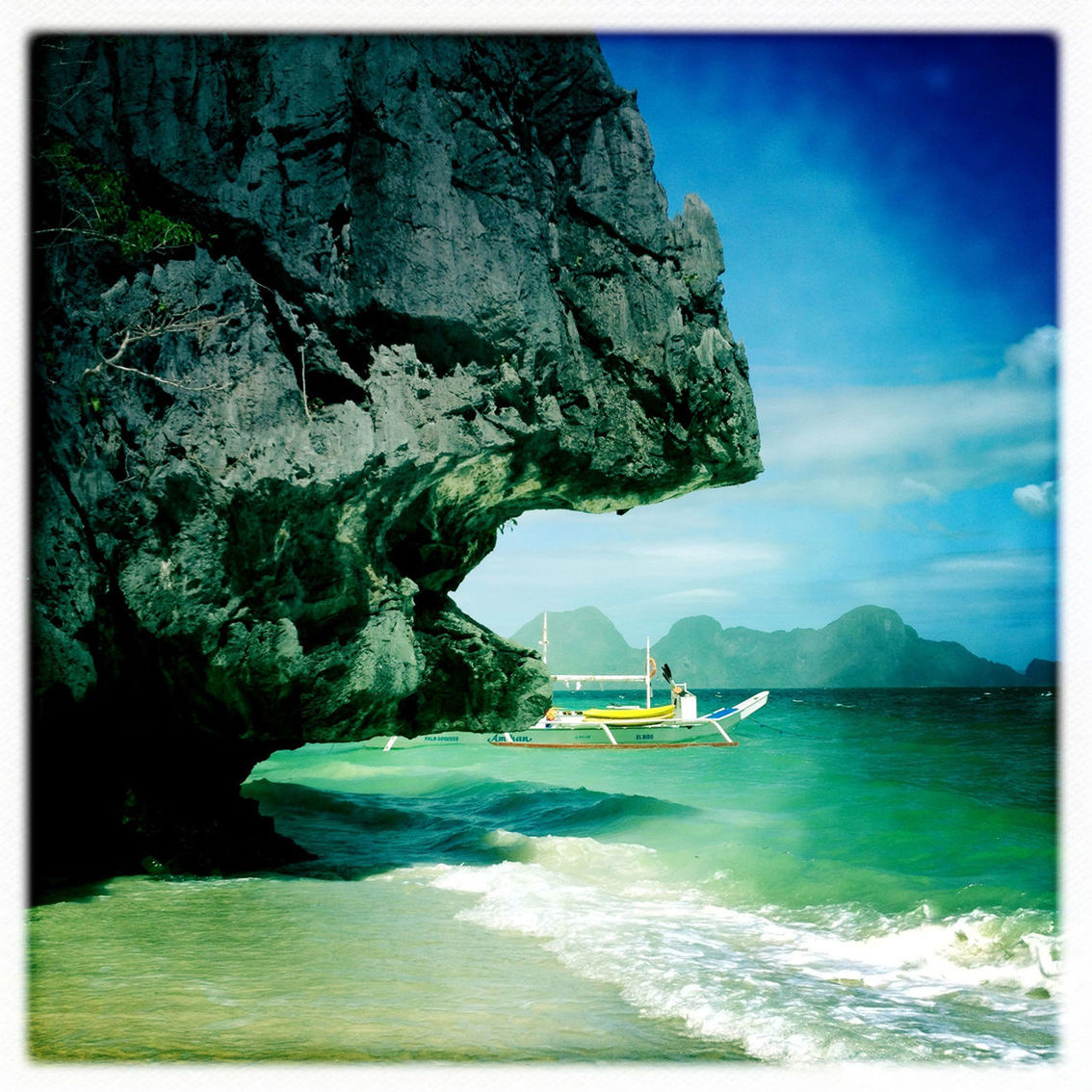 SCENIC VIEW OF SEA WITH MOUNTAINS IN BACKGROUND