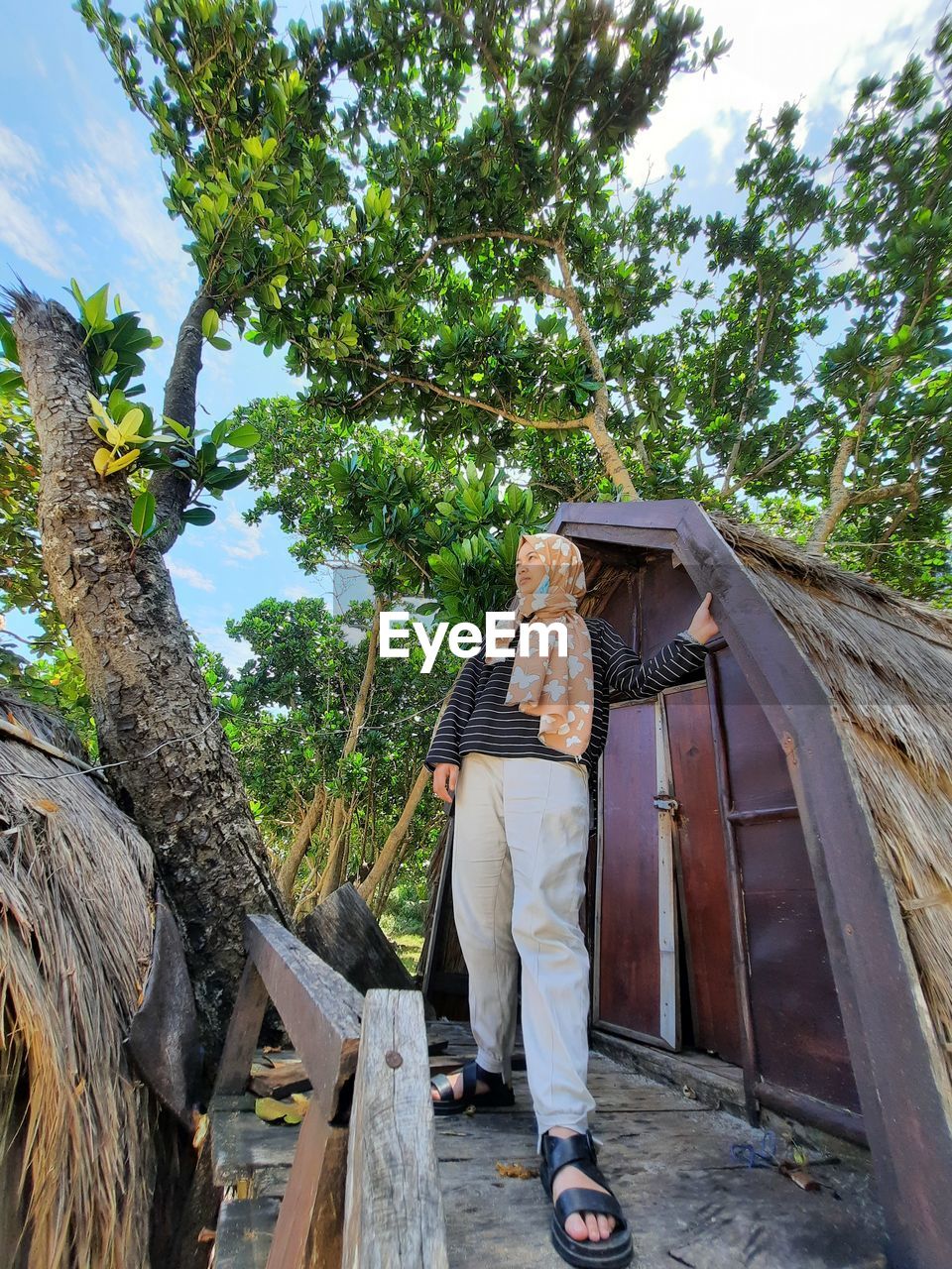 Girl standing on wooden house