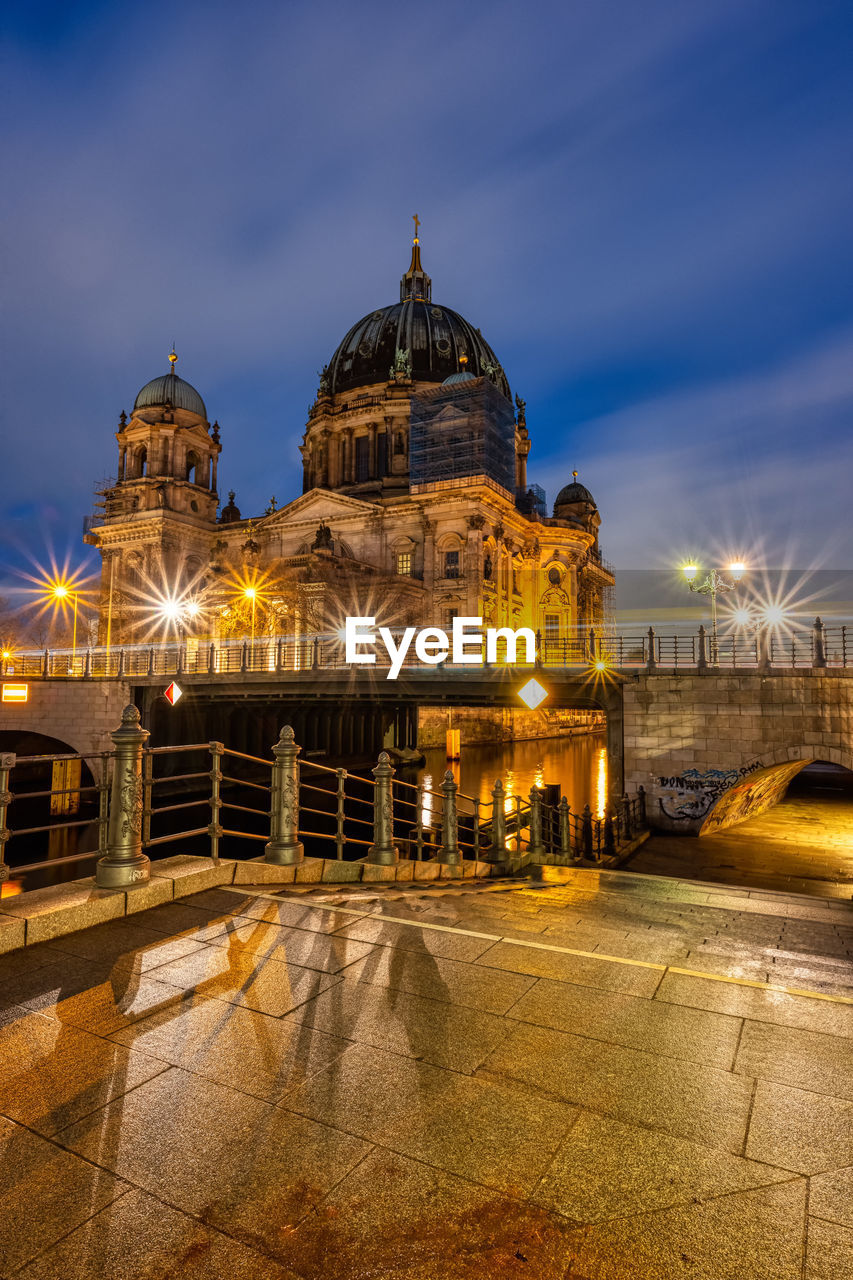 The imposing berlin cathedral at the banks of the river spree at night