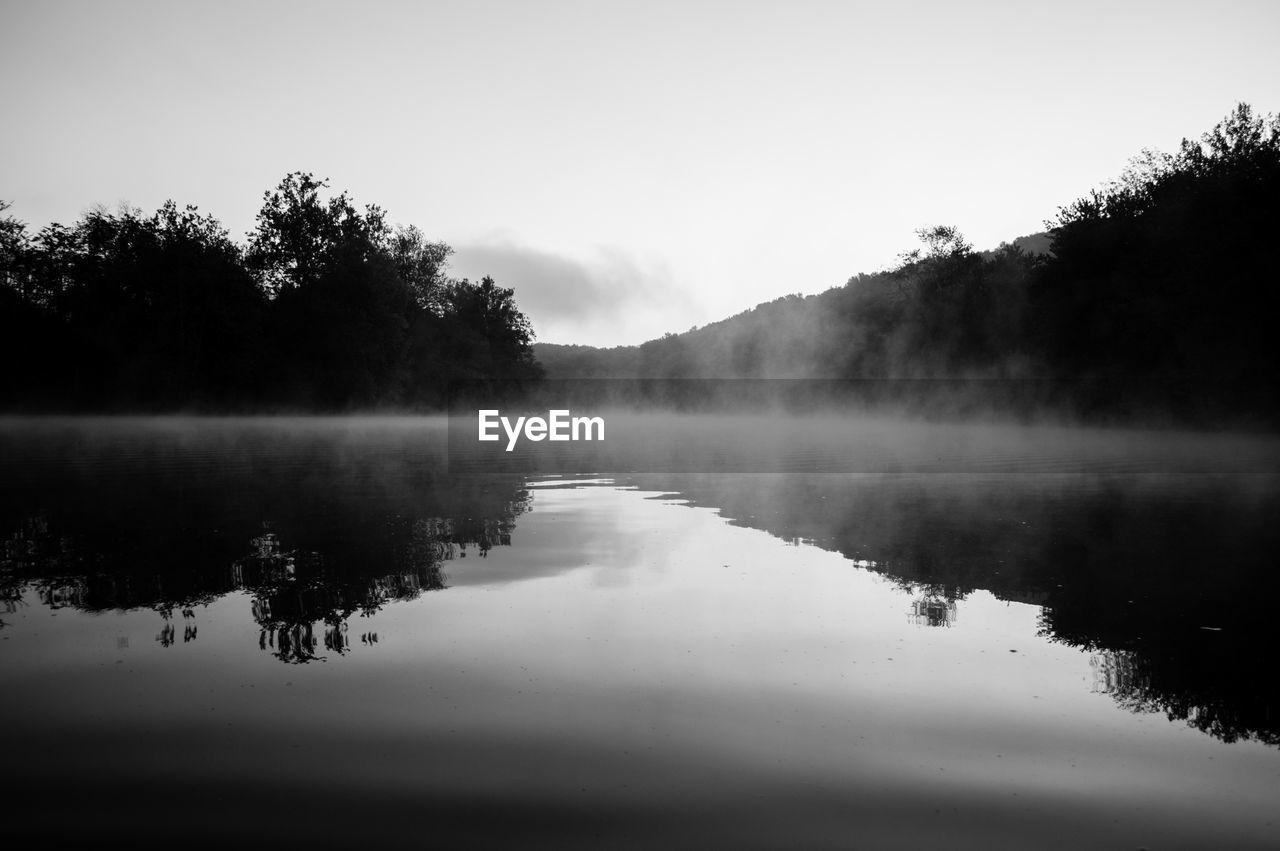 LAKE BY TREES AGAINST SKY