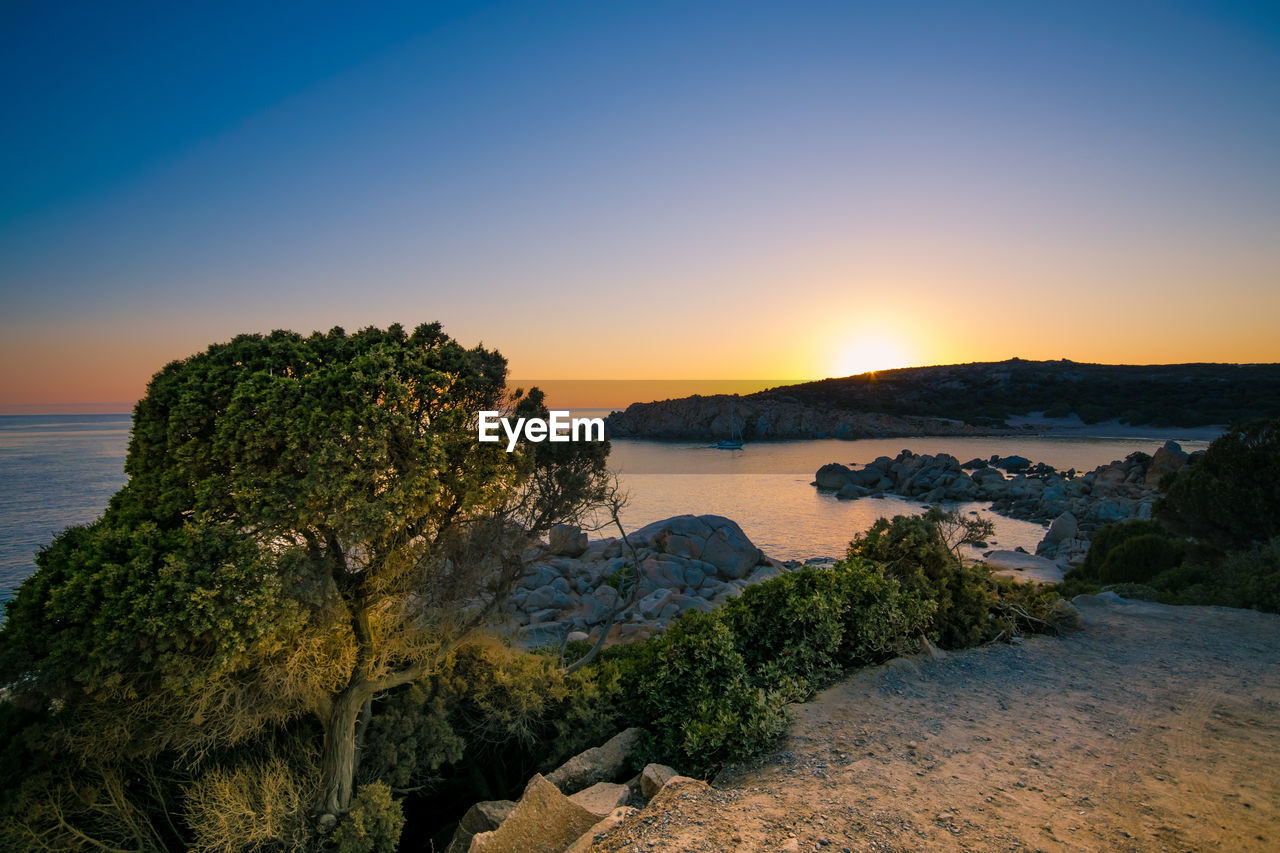 Scenic view of sea against clear sky during sunset