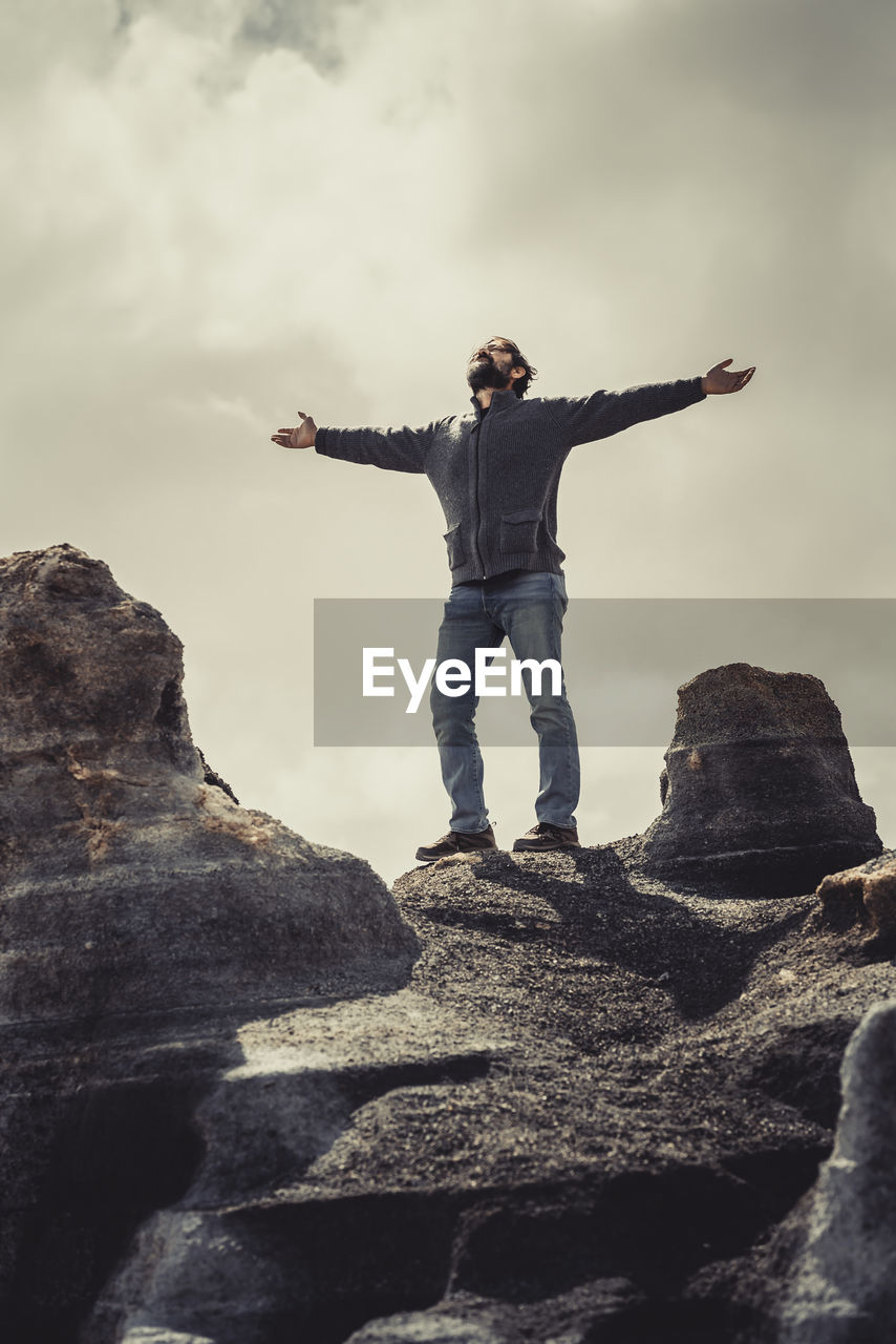 rear view of man standing on rock