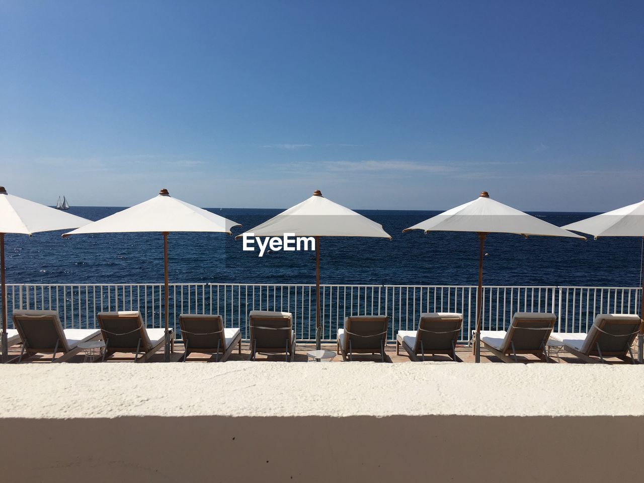 CHAIRS ON BEACH AGAINST SKY