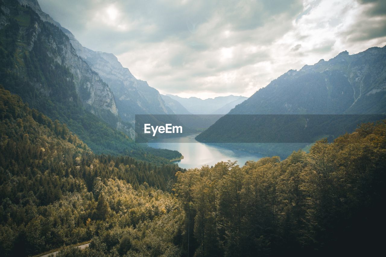 Scenic view of lake amidst mountains against sky