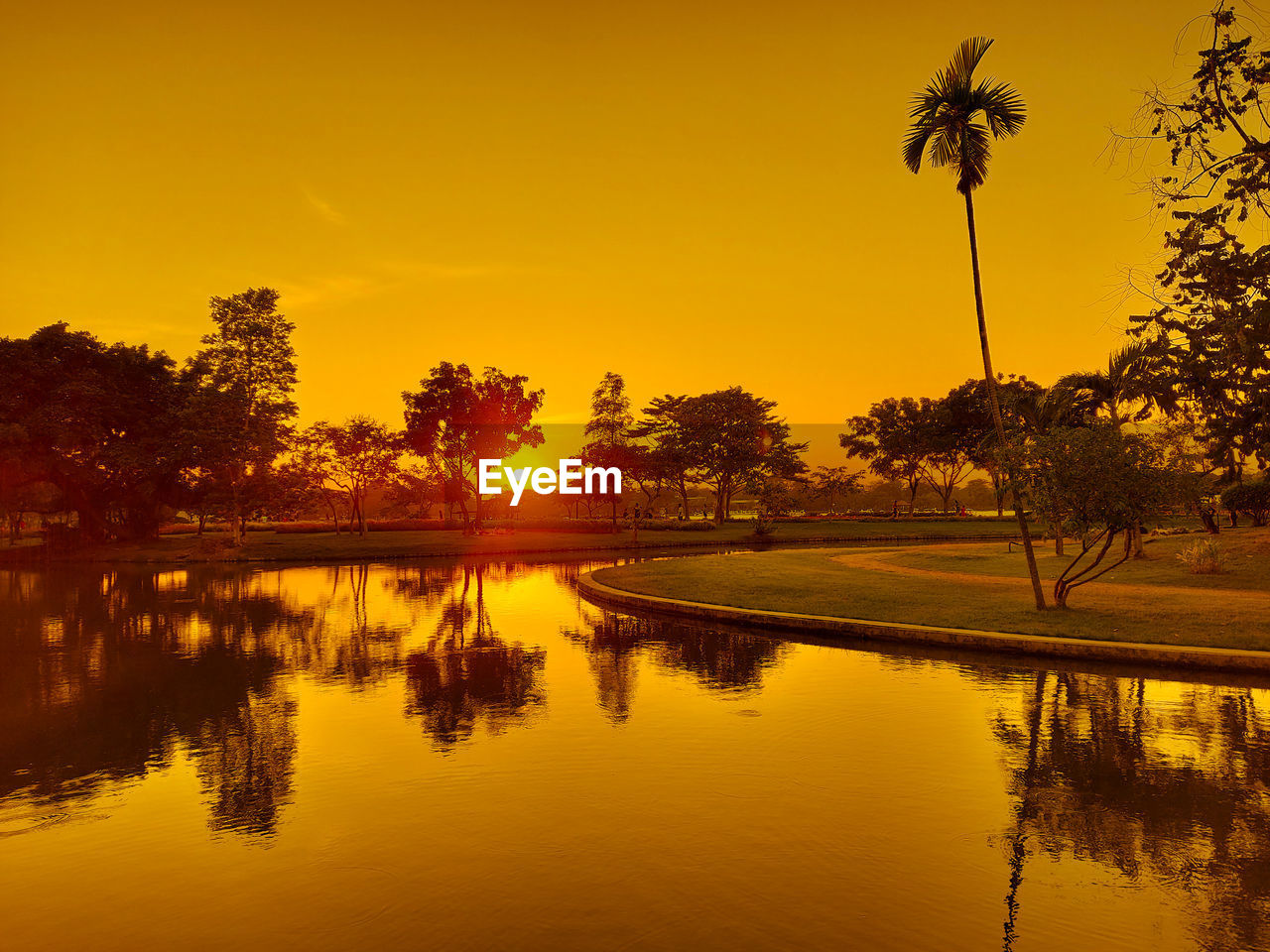 Scenic view of lake against romantic sky at sunset