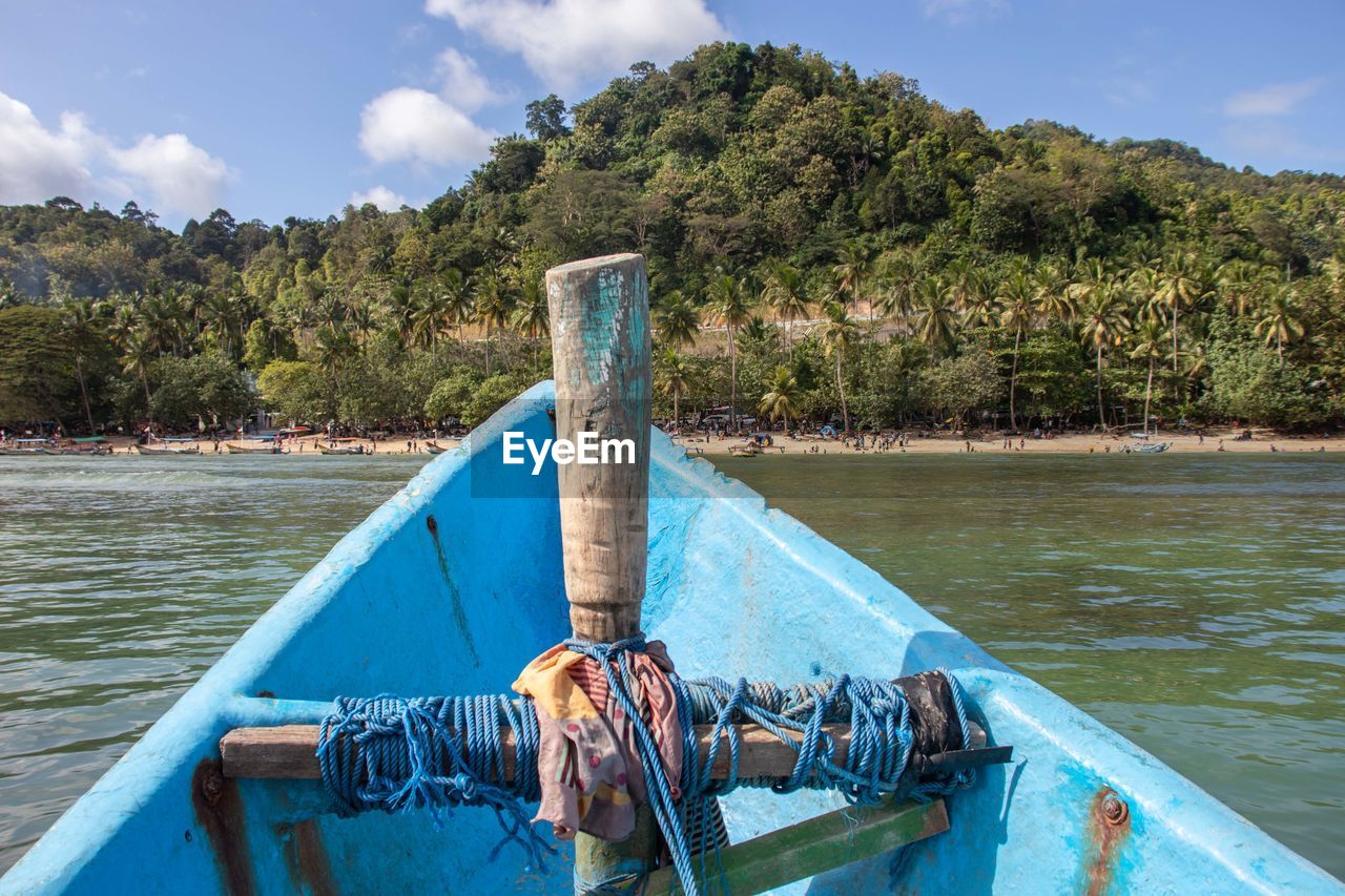 water, boat, nature, vehicle, transportation, tree, nautical vessel, sky, boating, sea, vacation, plant, day, mode of transportation, no people, blue, outdoors, scenics - nature, travel, cloud, land, travel destinations, tranquility, watercraft, beauty in nature, paddle, wood, tranquil scene, mountain