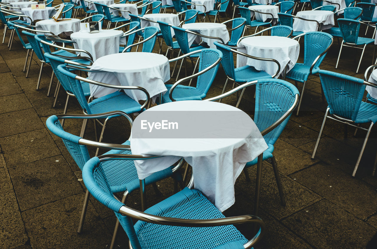 High angle view of blue chairs and tables