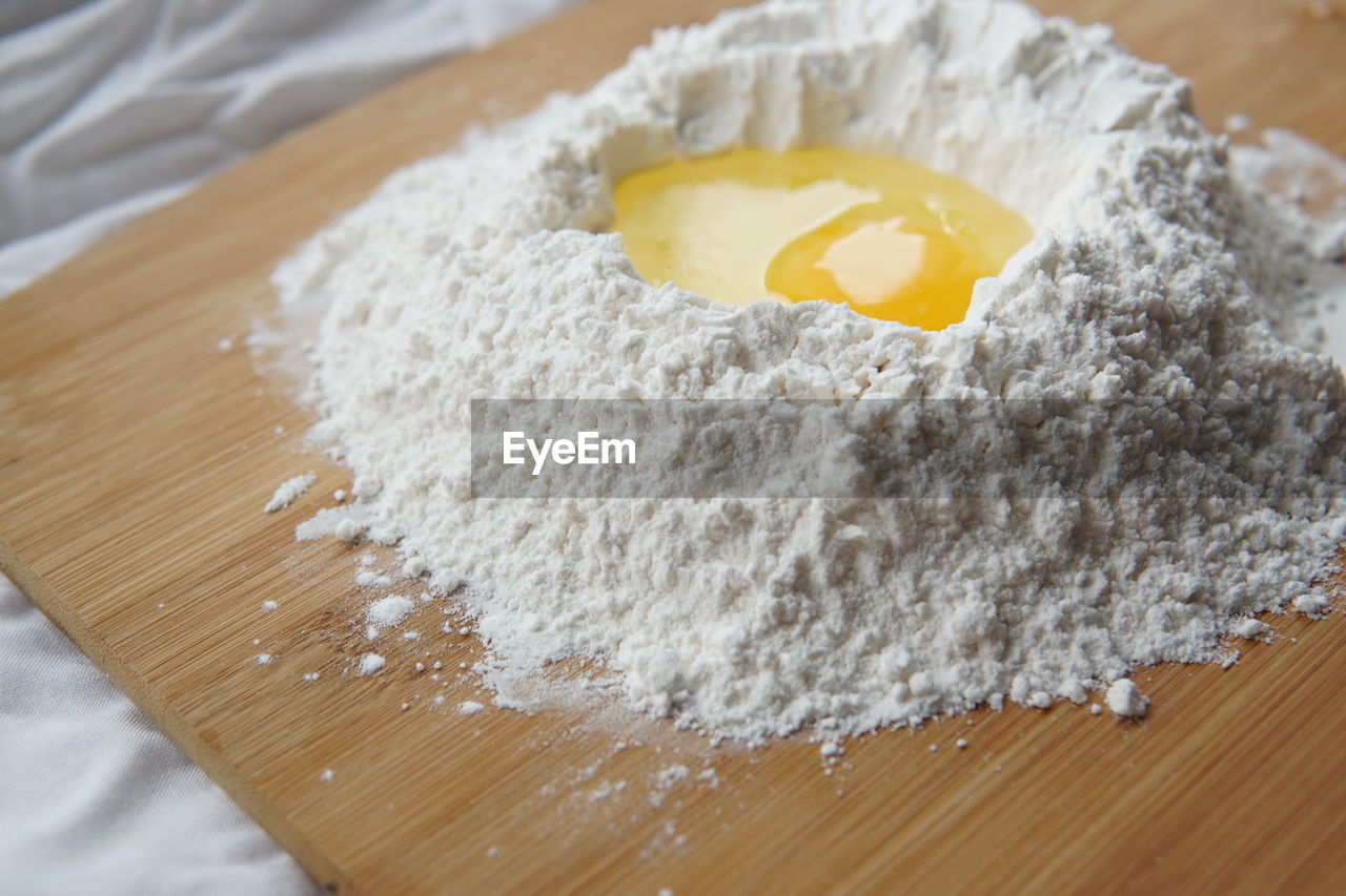 Close-up of egg and flour on table