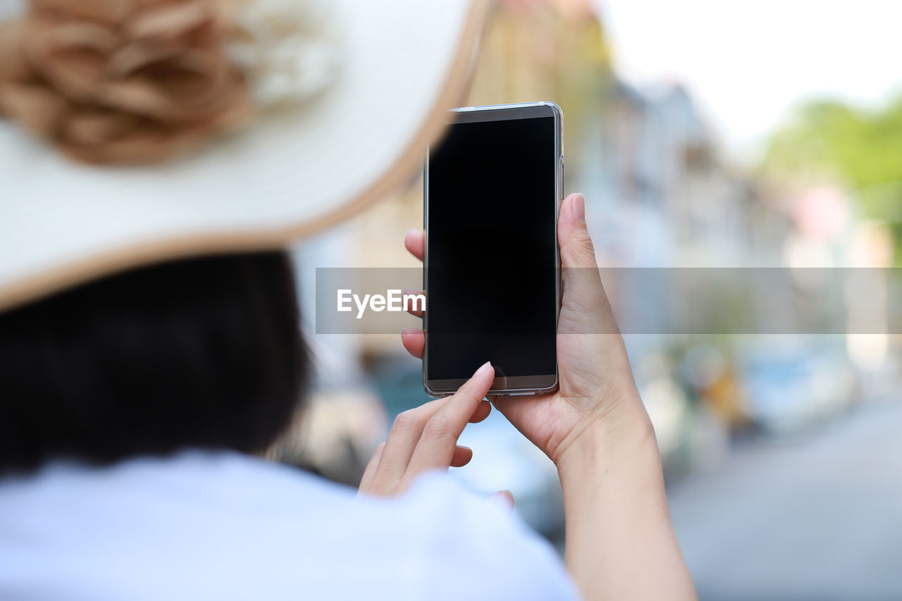 Rear view of woman using phone