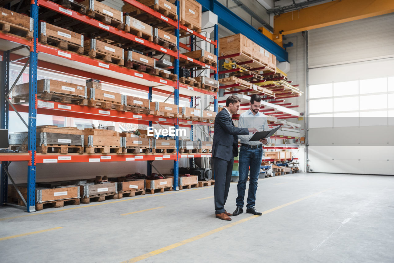 Two men walking and talking in factory shop floor