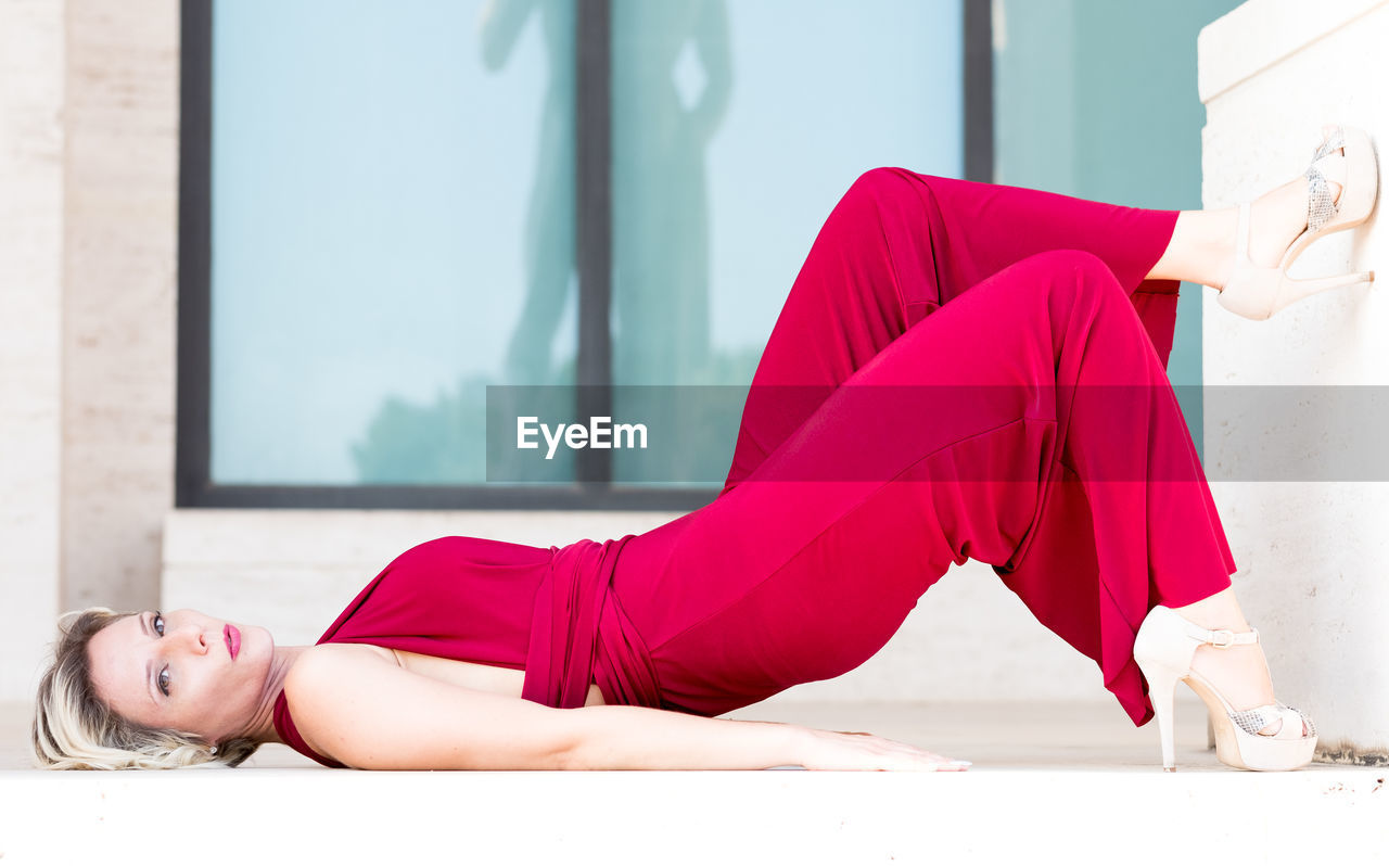 Side view of young woman lying down