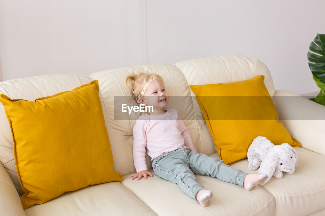 low section of woman sleeping on sofa at home