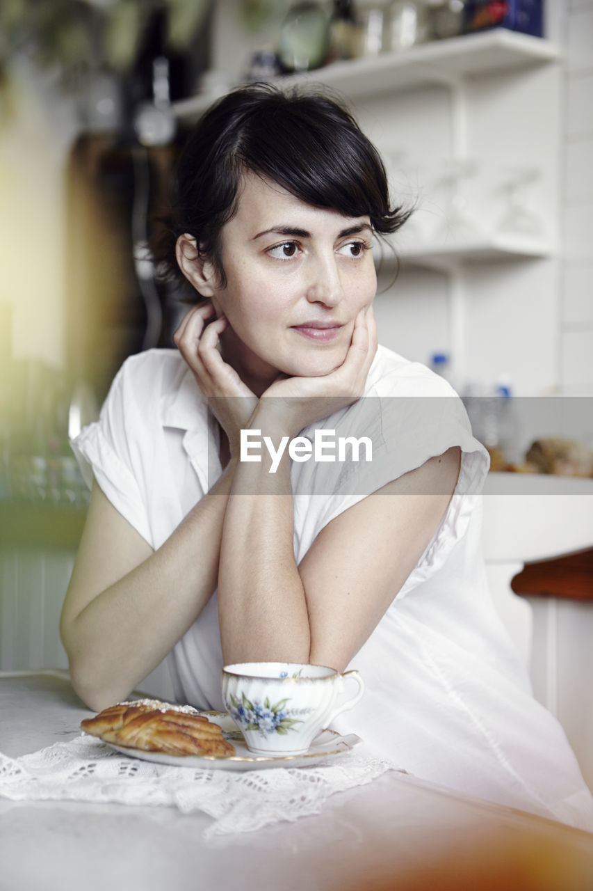 Young woman having tea