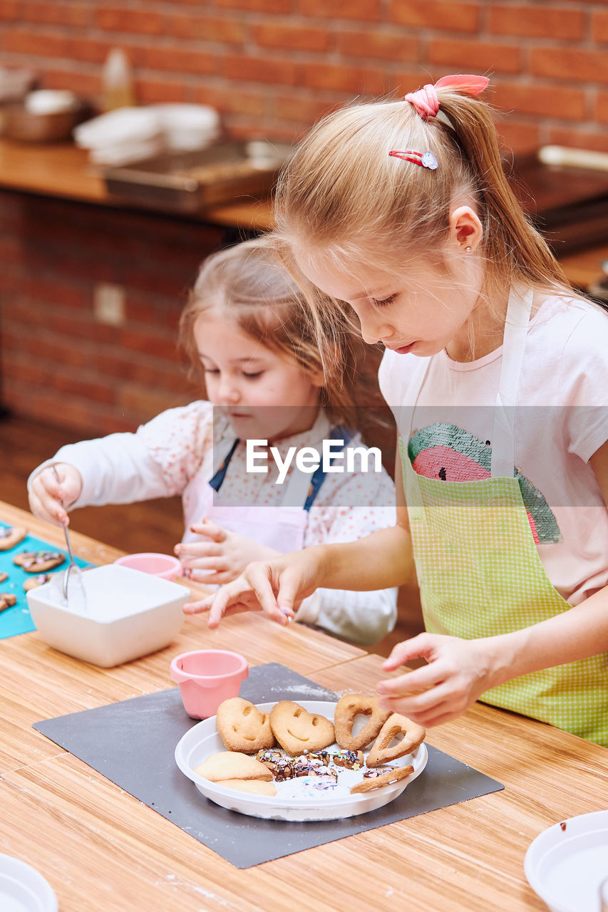 MOTHER AND GIRL PREPARING FOOD