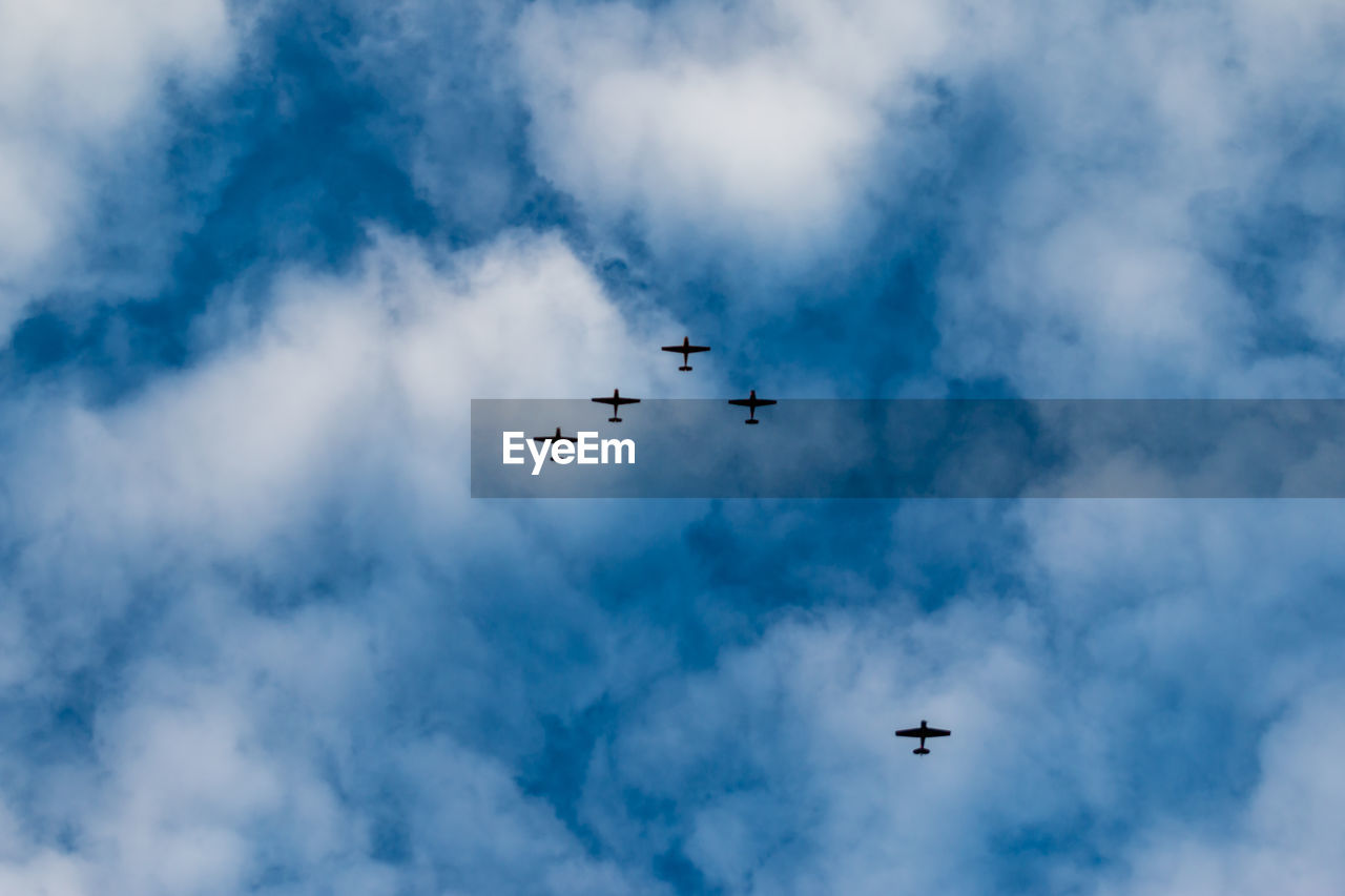 Low angle view of airplane flying against sky