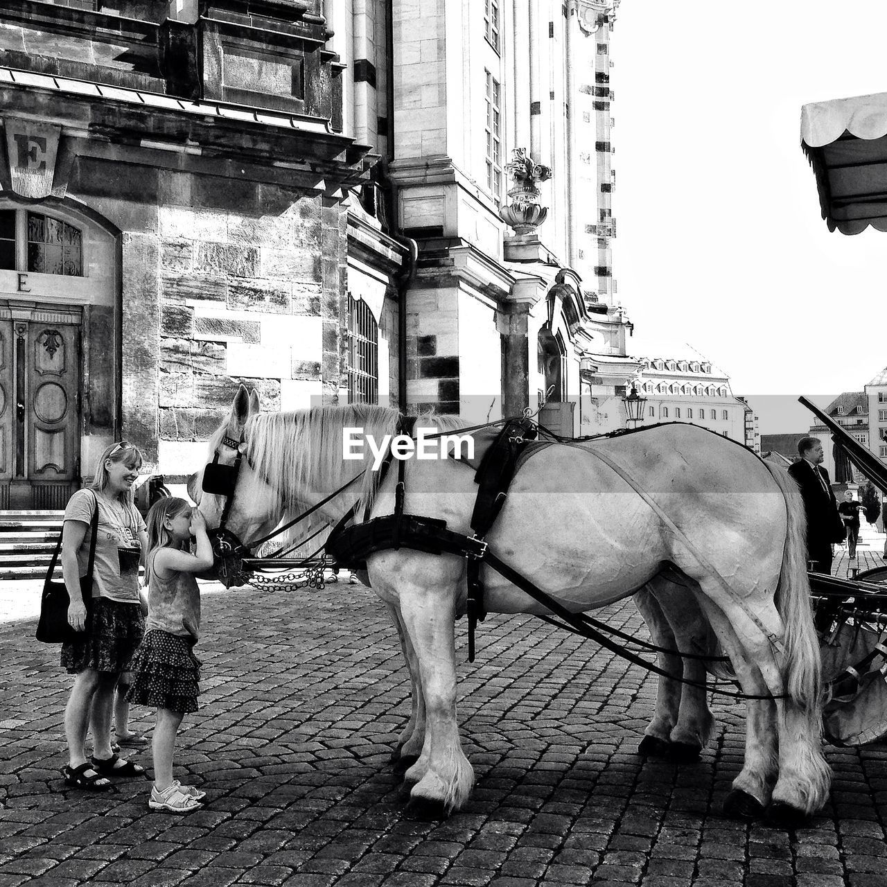 WOMAN STANDING ON CITY STREET