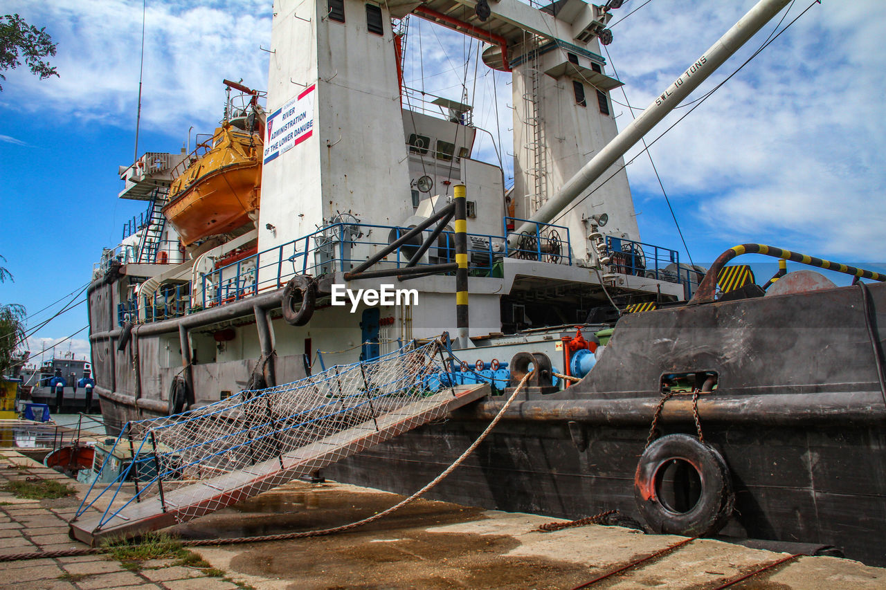 VIEW OF SHIP MOORED ON SHORE