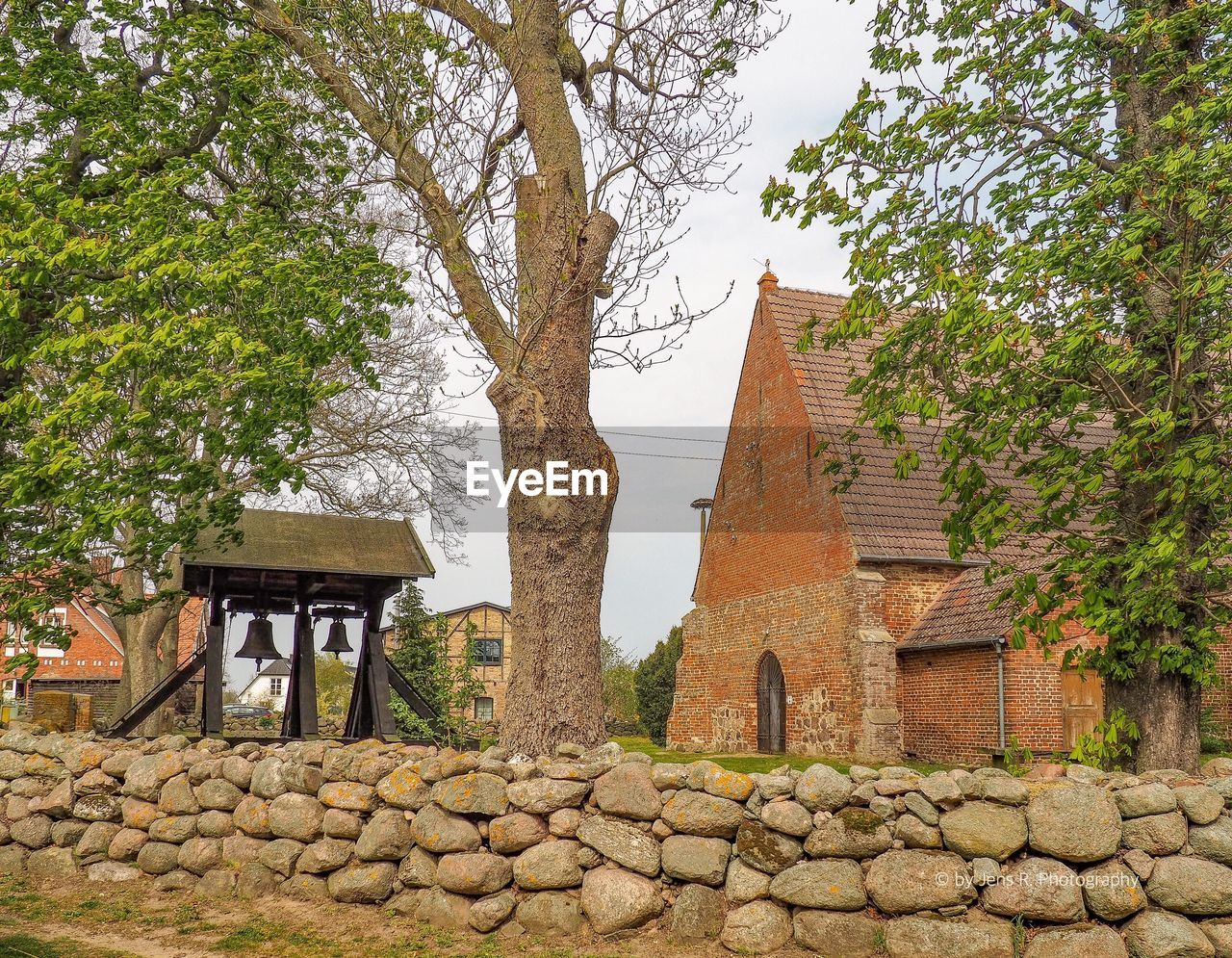 EXTERIOR OF OLD BUILDING BY TREES