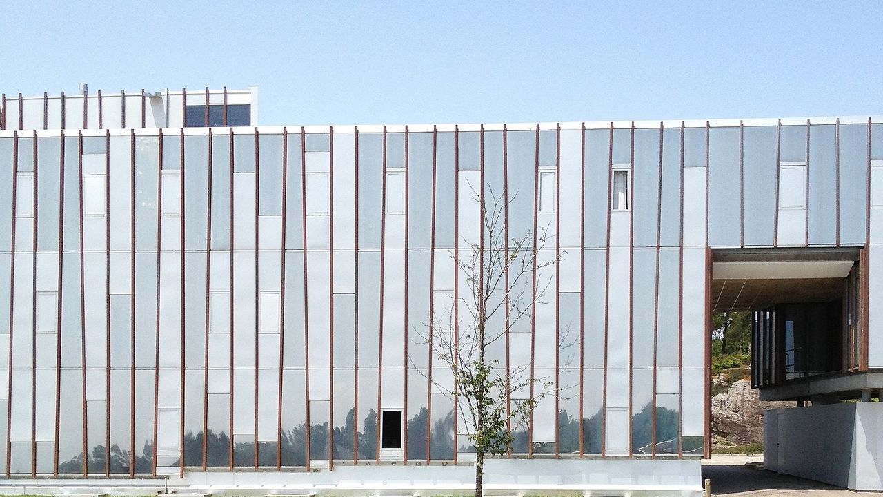Entrance of building against blue sky