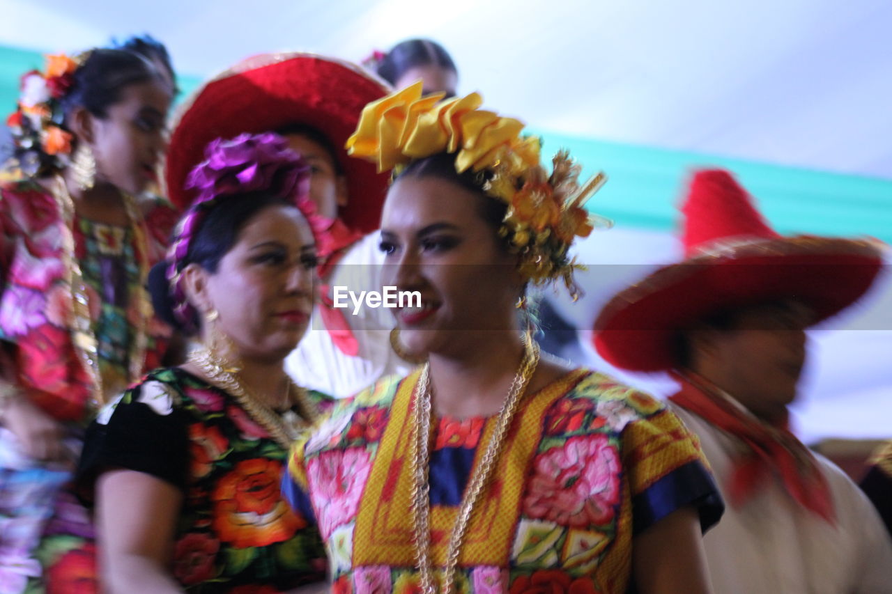 PORTRAIT OF YOUNG WOMAN IN TRADITIONAL CLOTHING