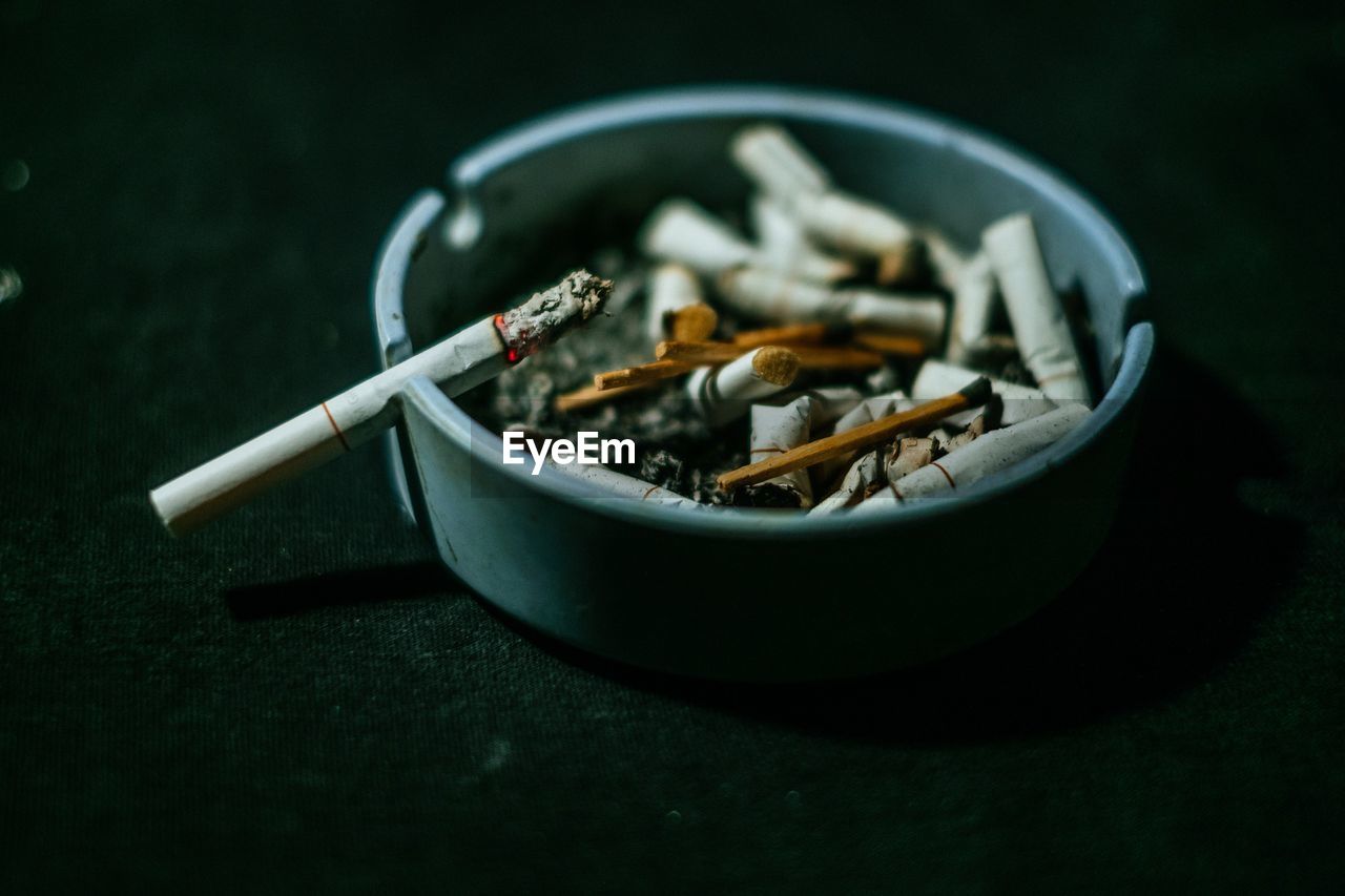 Close-up of cigarette in container