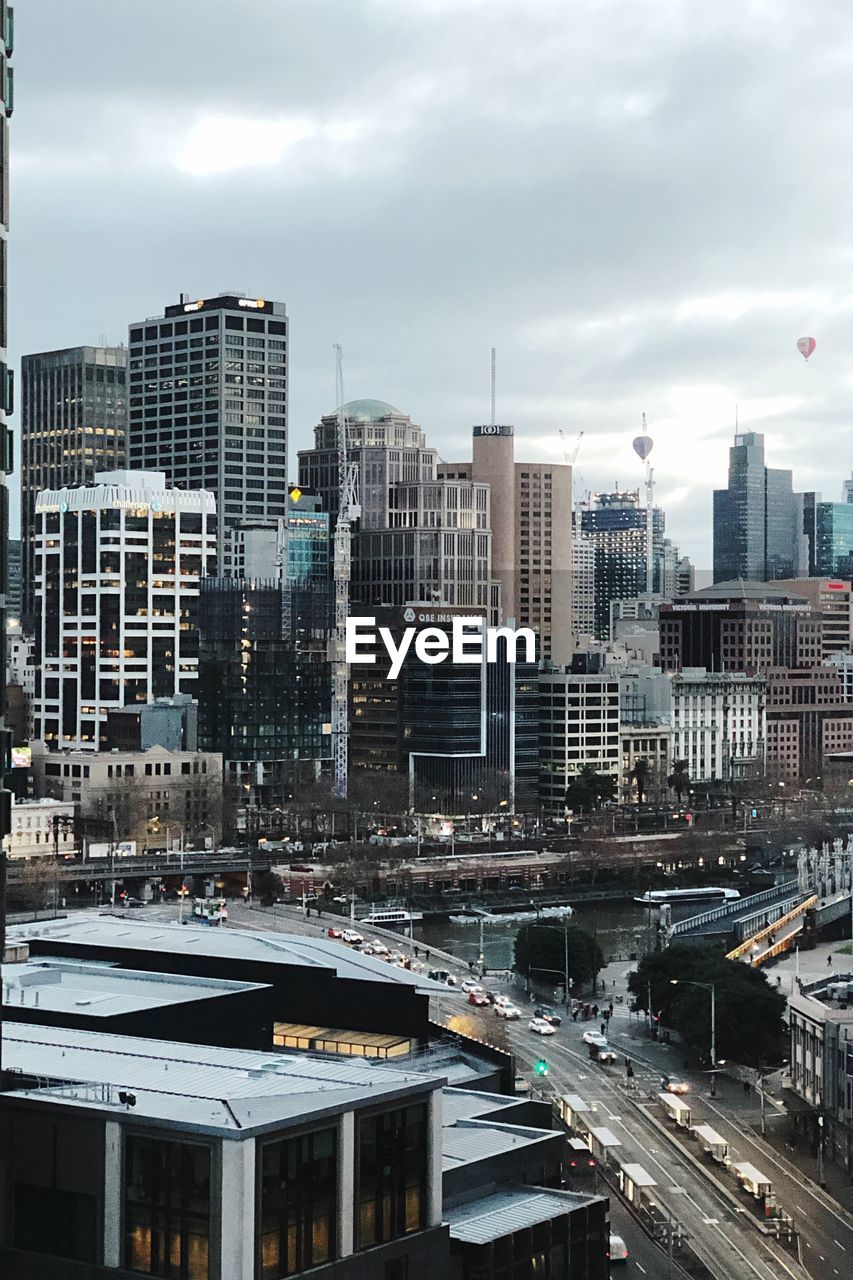 HIGH ANGLE VIEW OF BUILDINGS AND CITY AGAINST SKY